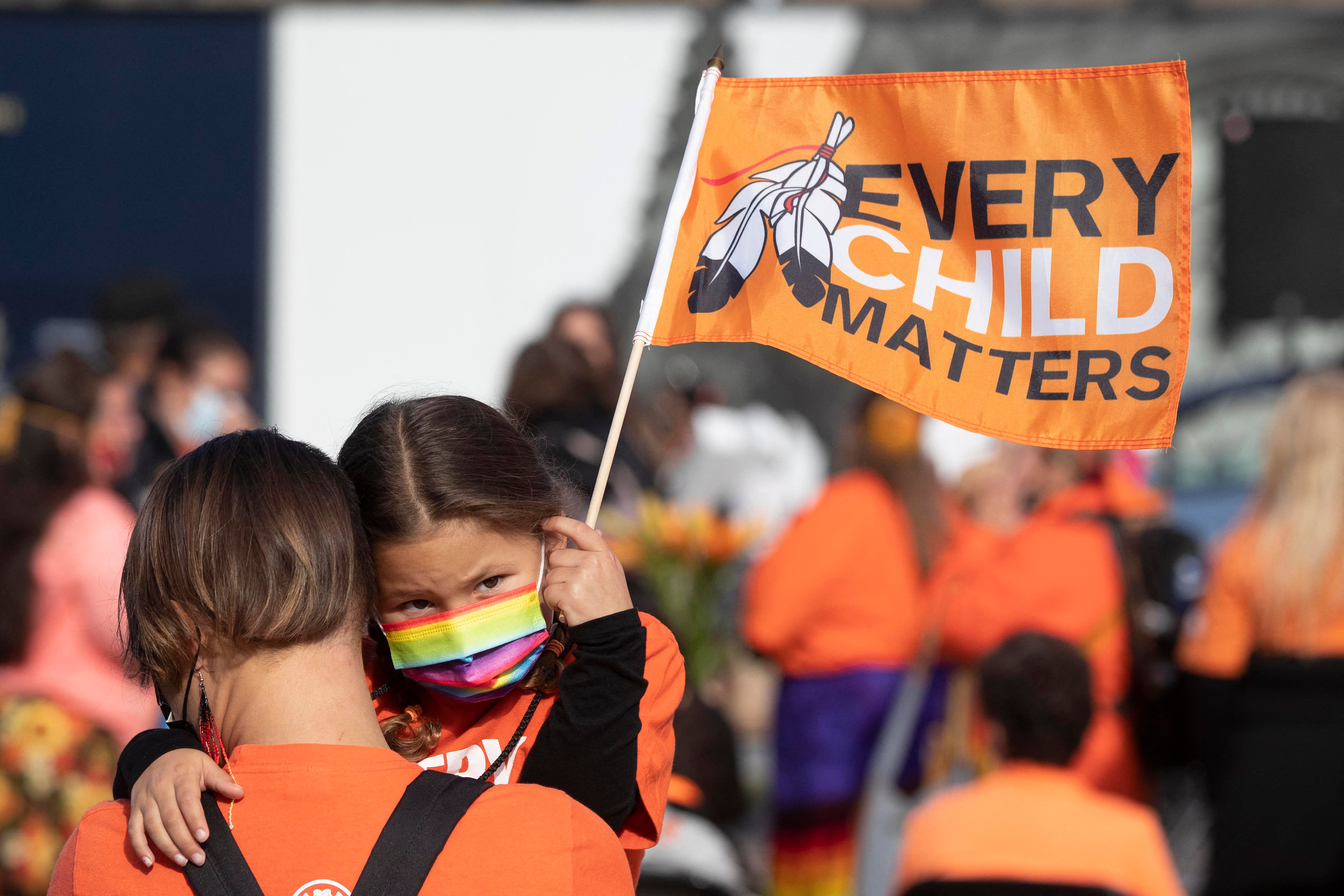 An indigenous child holds a flag during the first National Day for Truth and Reconciliation, on Parliament Hill in Ottawa in September