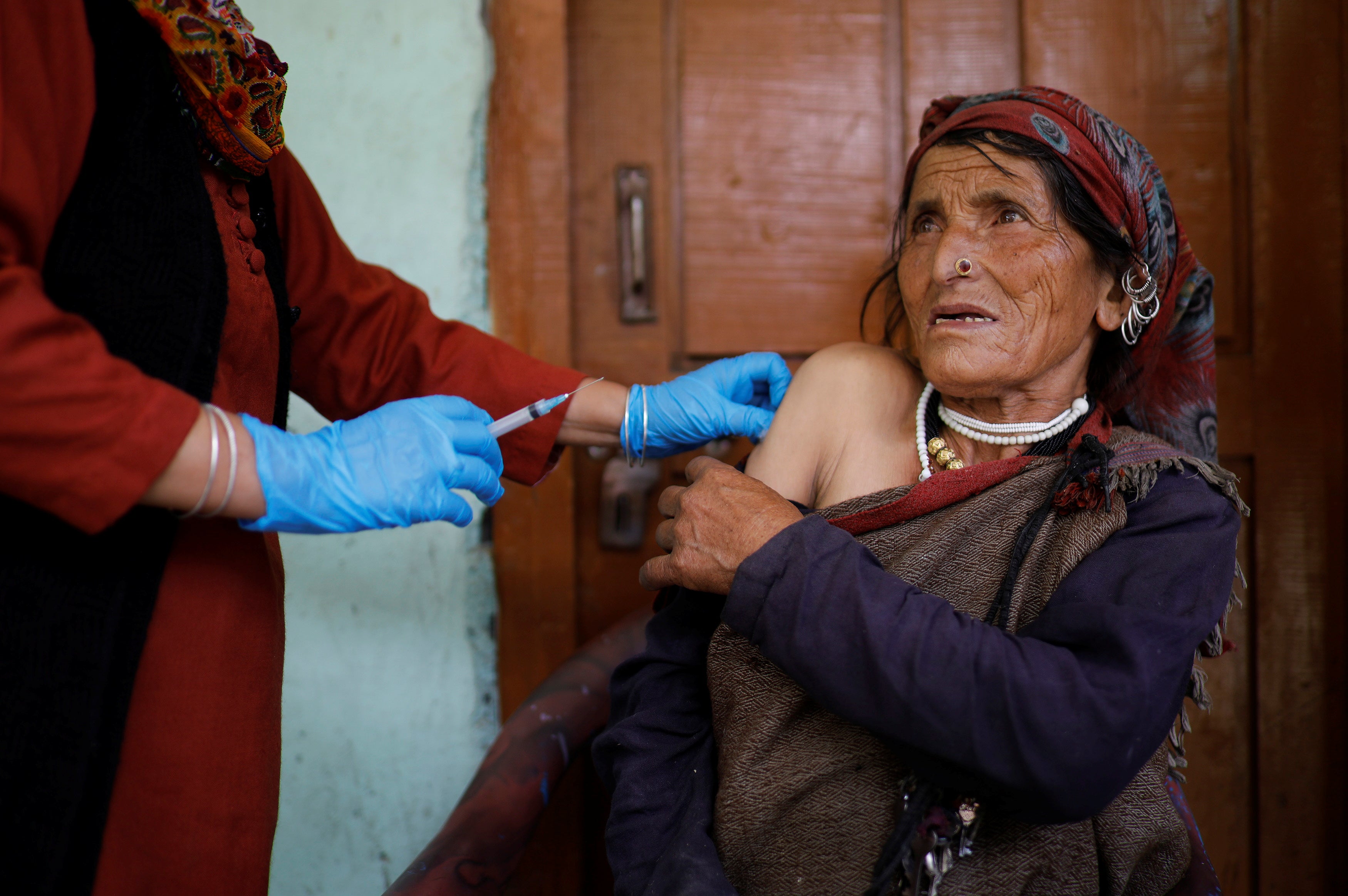 A local priest invoked a Hindu deity before the villagers received their jabs