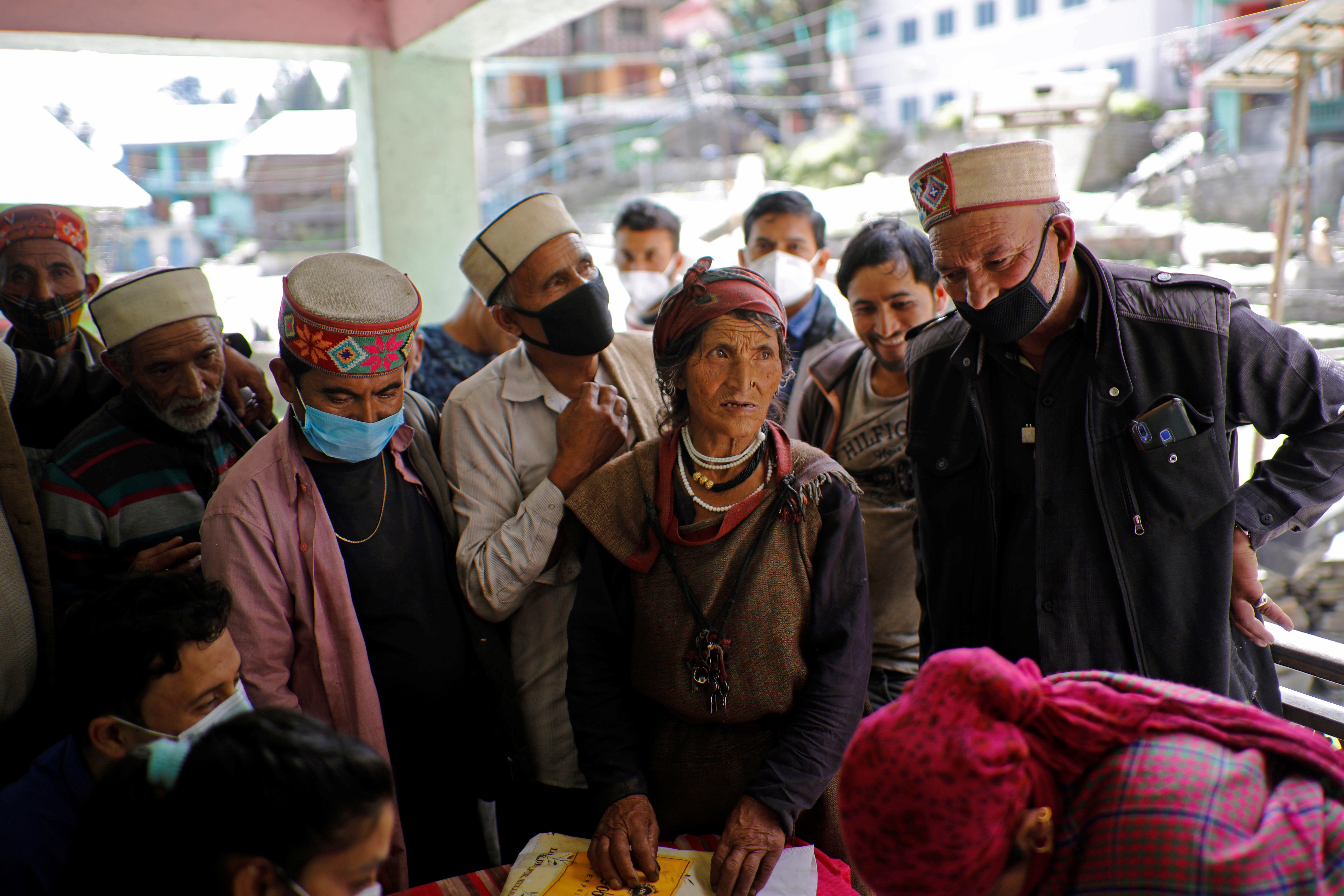 Villagers wait to receive their doses