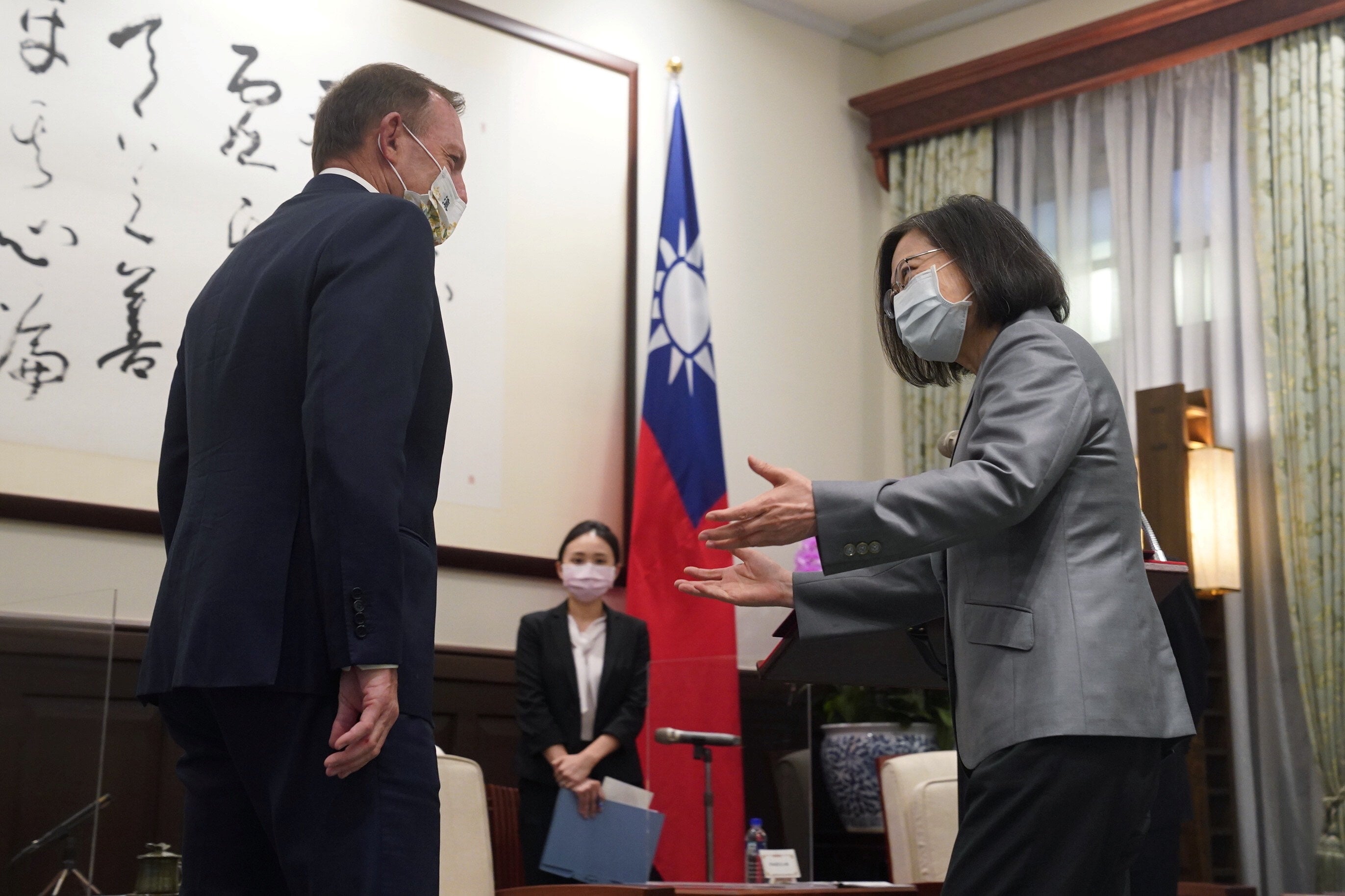 Taiwan’s President Tsai Ing-wen speaks to the former Australian Prime Minister Tony Abbott during their meeting in Taipei