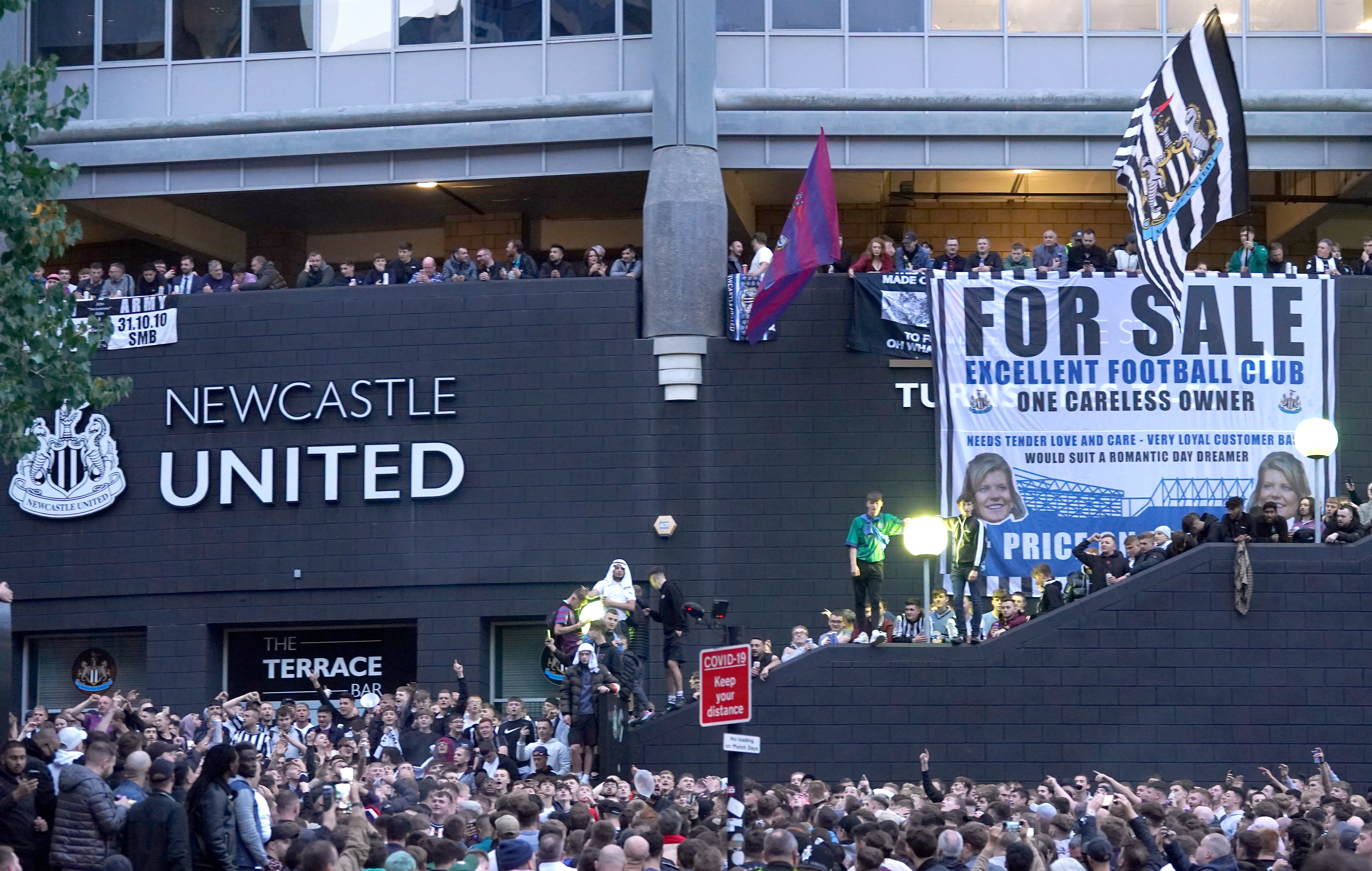 Newcastle fans celebrate the completion of the takeover