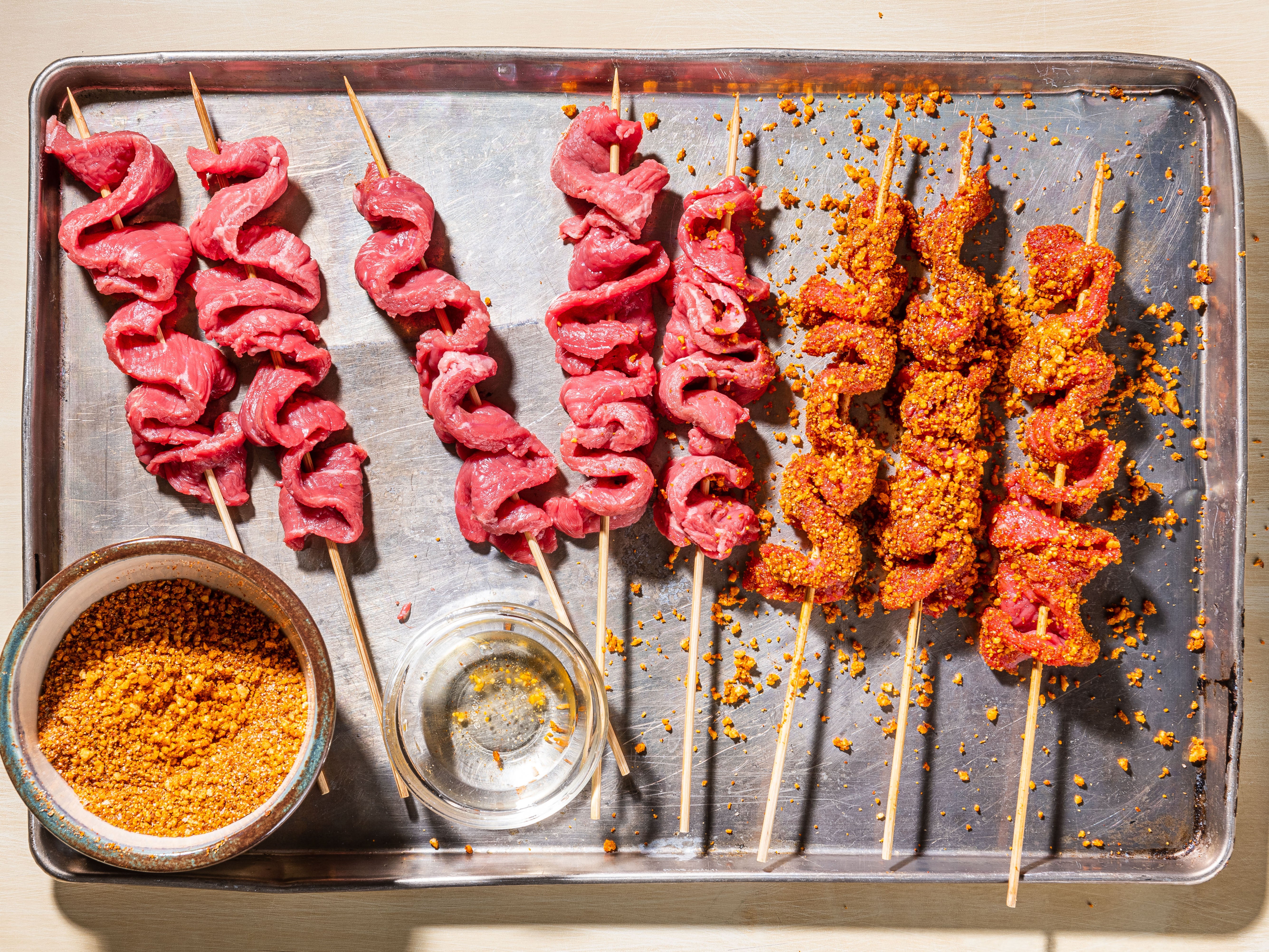 To make it, thin ribbons of beef are threaded onto skewers, coated in a punchy spice mixture and grilled until lightly charred