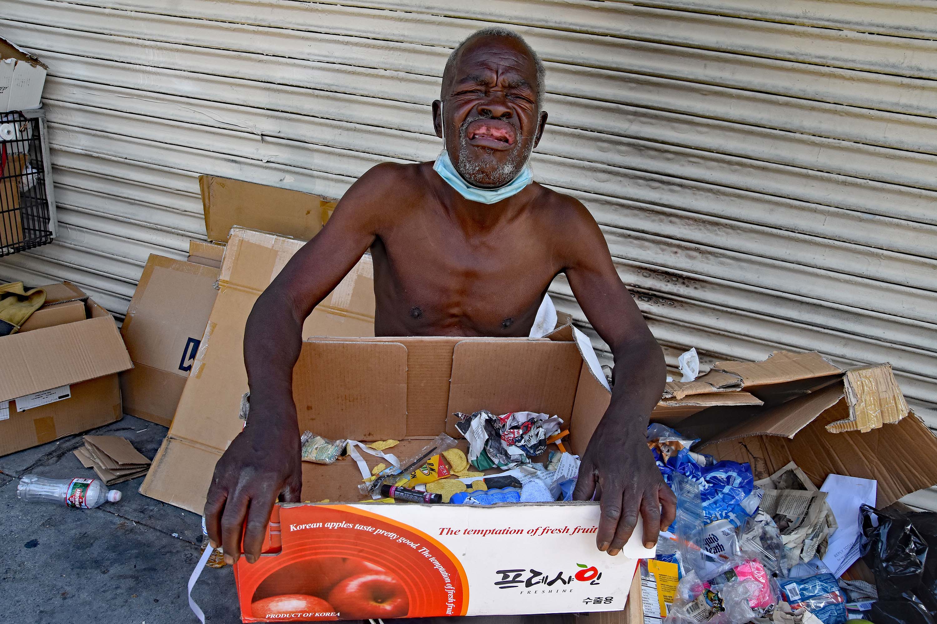 On 3rd Street, a man lives among cardboard boxes