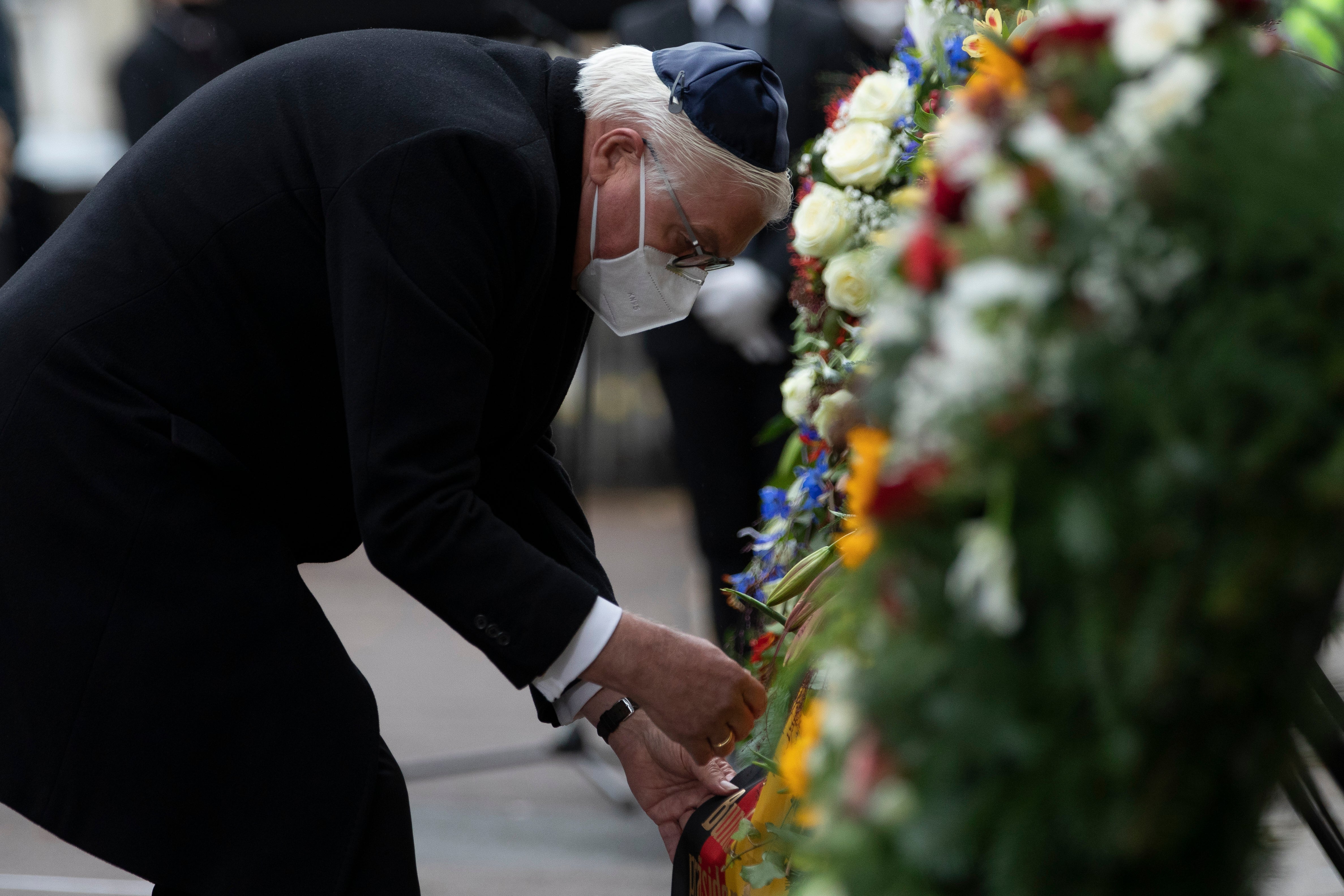 German President Frank-Walter Steinmeier puts a wreath next to the Halle synagogue during commemorations on the first anniversary of the attack that left two people dead on October 09, 2020 in Halle