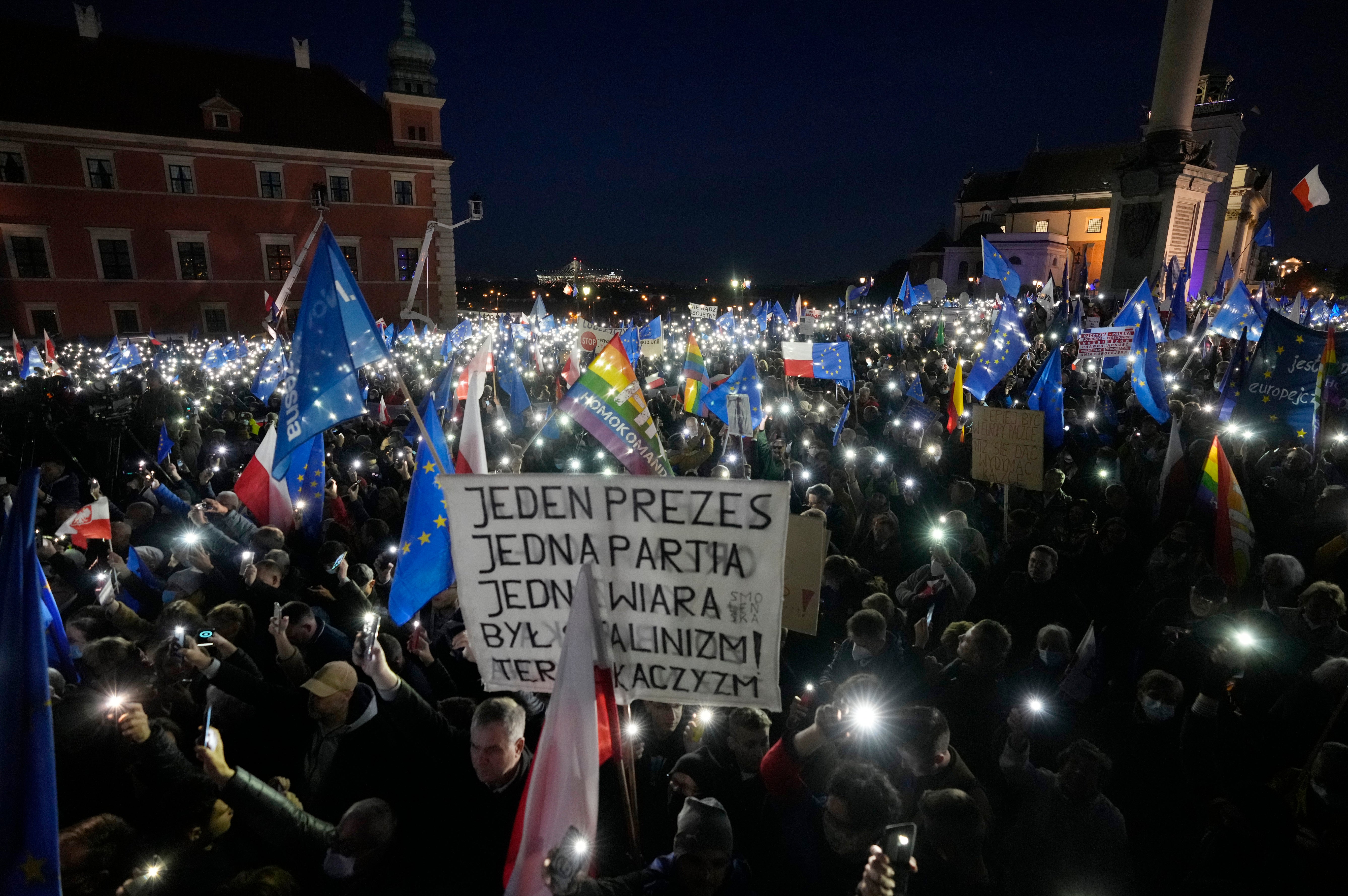 One protester holds up a sign that reads: ‘One leader, one party, one creed. Once it was Stalinism, now it it’s Kaczynski-ism’