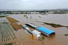 China flooding: Bus swept away and millions displaced by deadly deluge