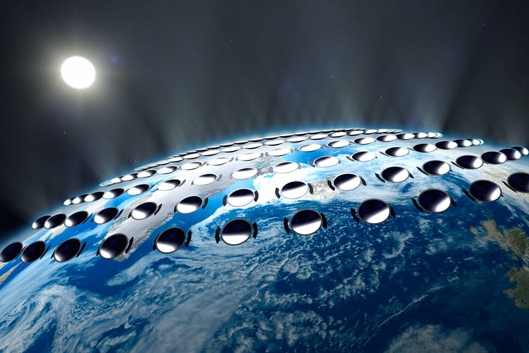 An artist’s impression of solar reflectors in space reflecting sunlight away from Earth