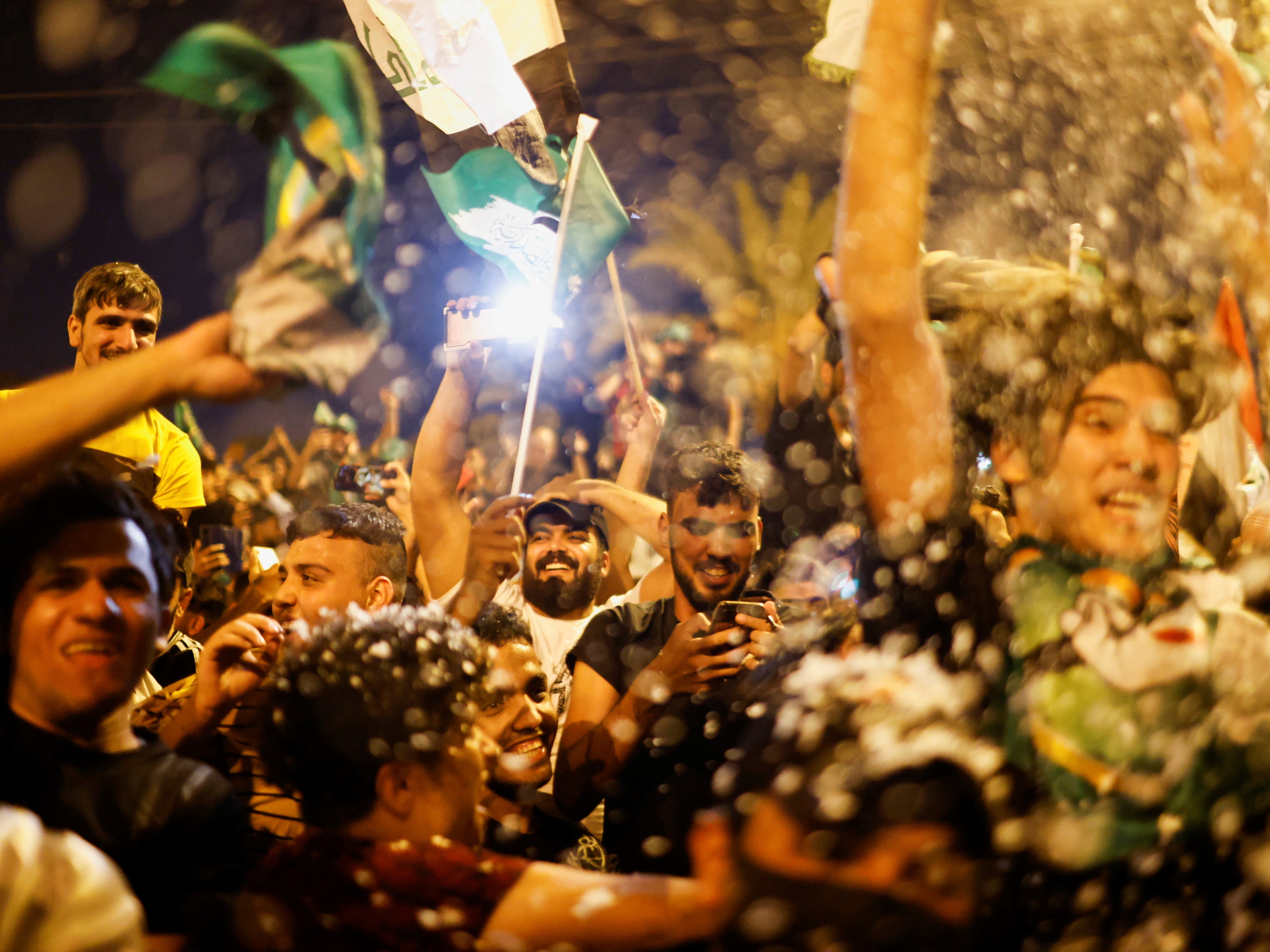 Supporters of Sadr’s movement celebrate after preliminary results of Iraq’s parliamentary election were announced in Baghdad