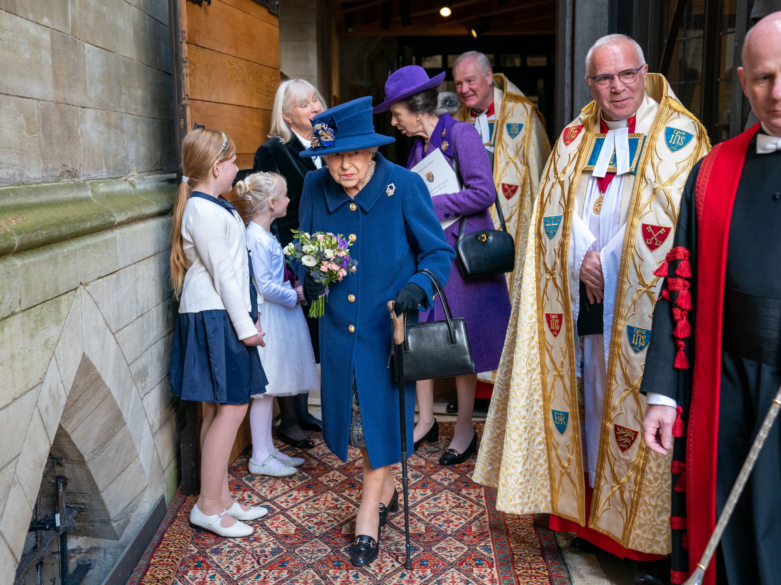 Queen Elizabeth II uses a walking stick as she arrives with the Princess Royal to attend a Service of Thanksgiving at Westminster Abbey in London to mark the Centenary of the Royal British Legion