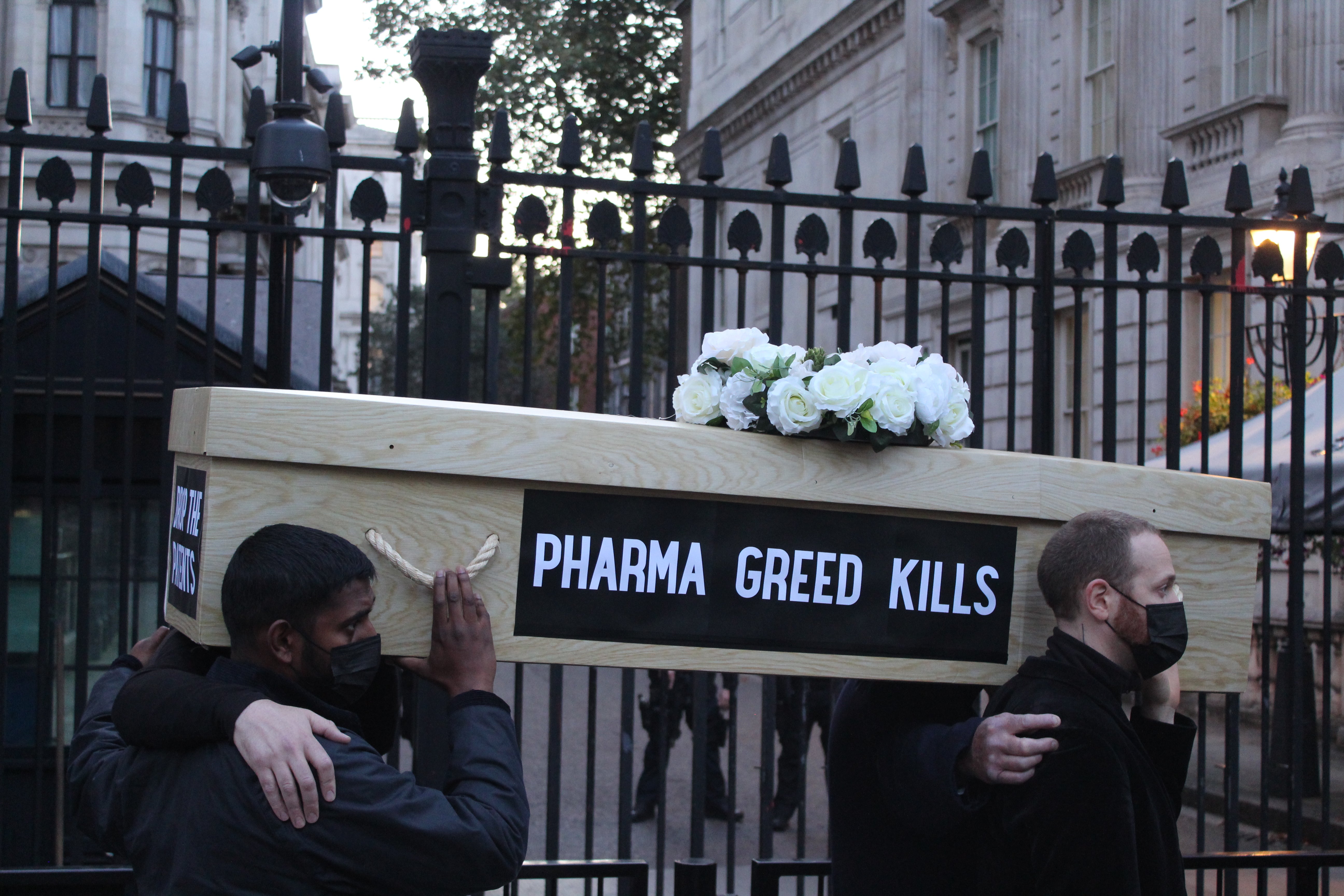 Protesters carry a coffin outside the gates of Downing Street on Tuesday evening.