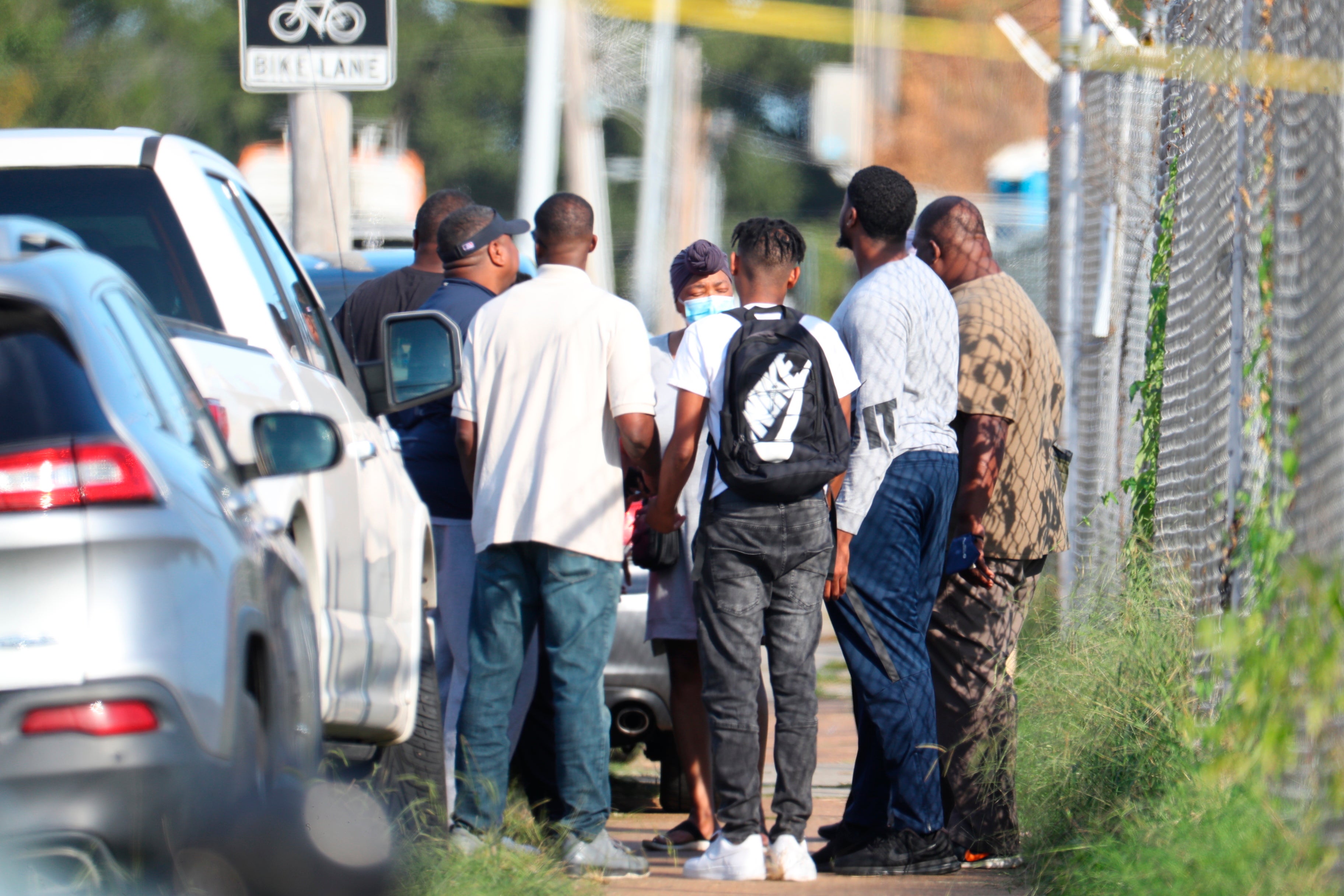 Family members of victims and employees pray outside of a post office after a shooting