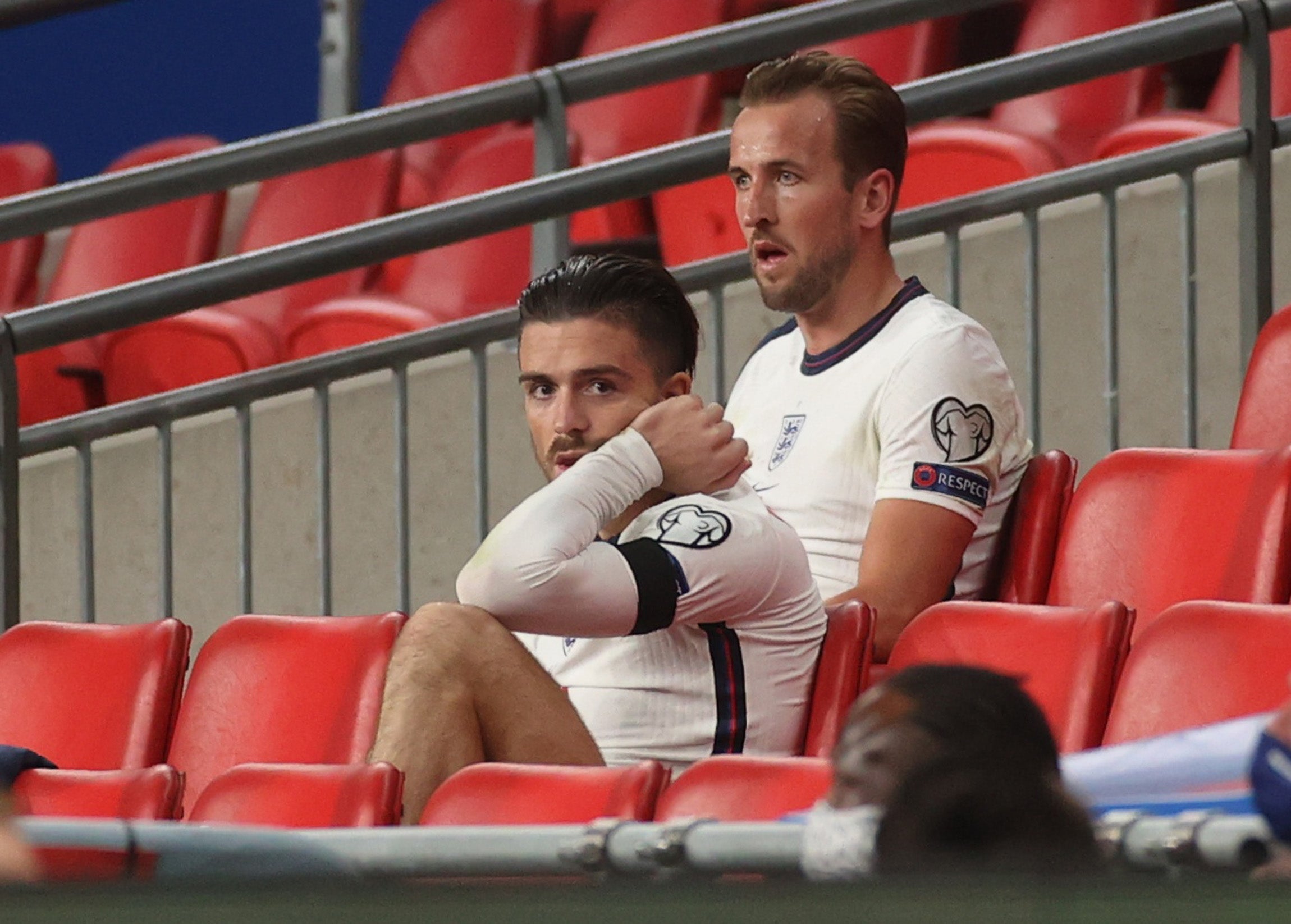 Harry Kane (right) and Jack Grealish look on from the bench at Wembley