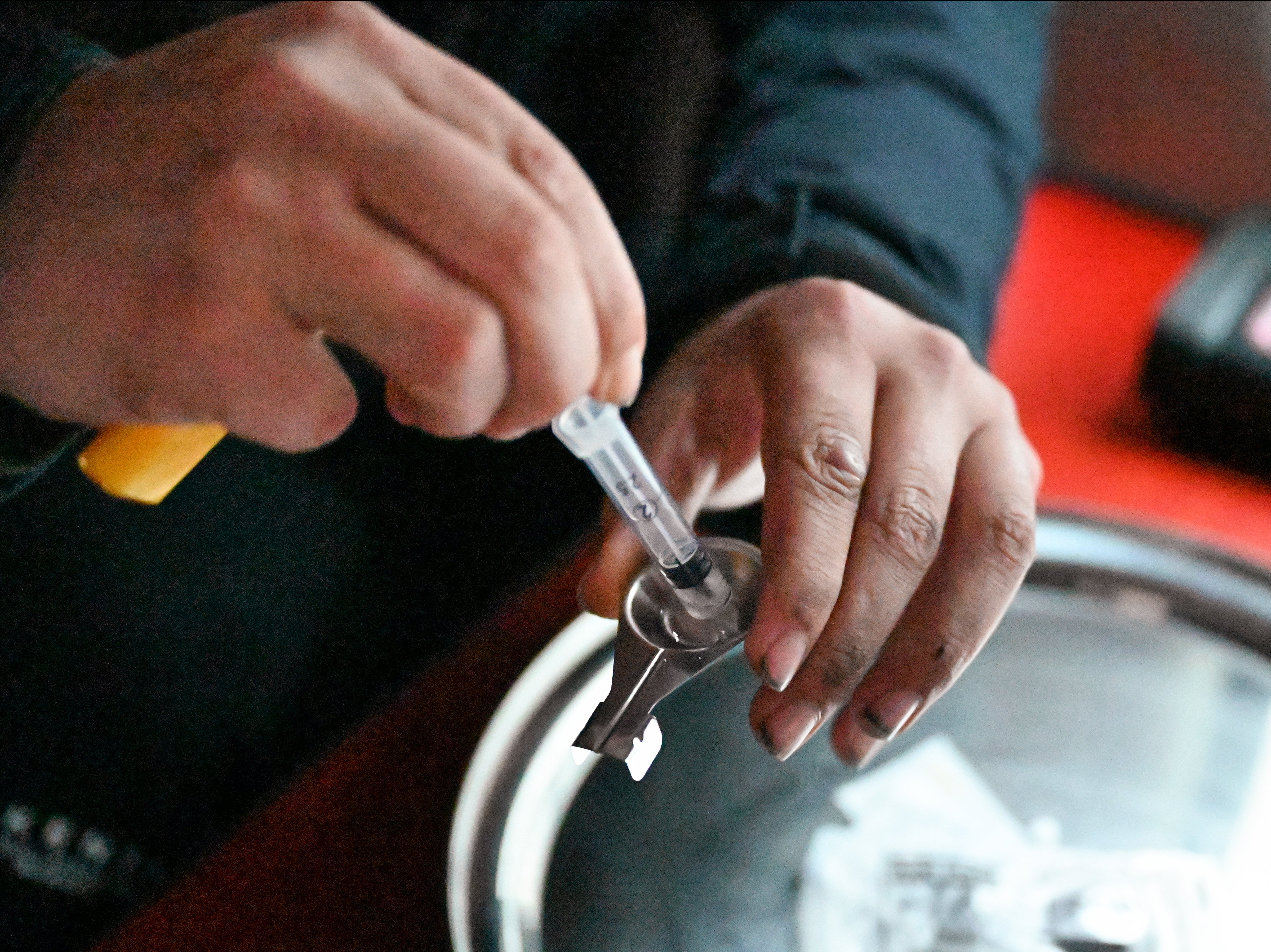 Drug users prepare cocaine before injecting, inside a safe consumption van set up by Peter Krykant in Glasgow