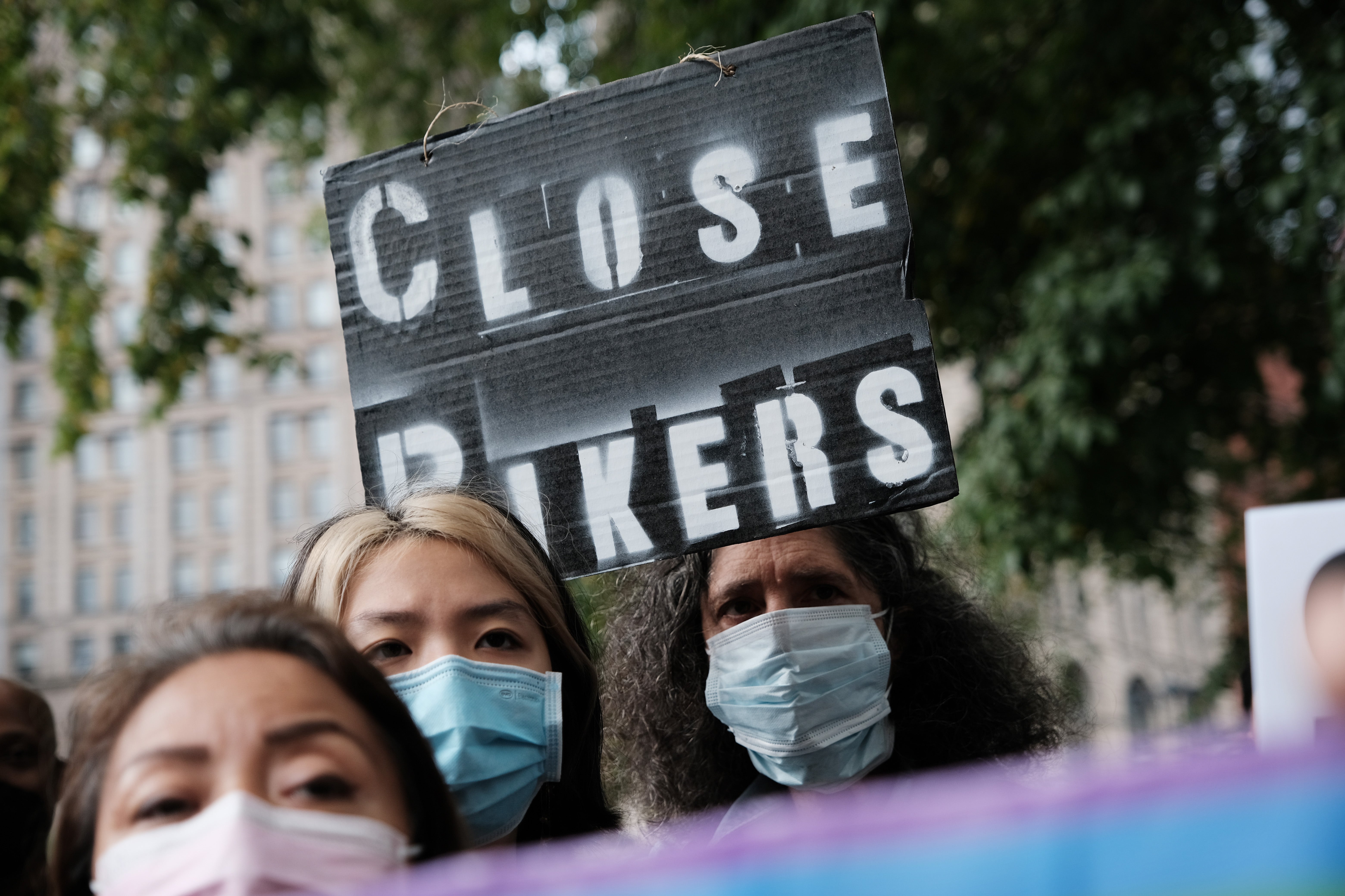 Families of Rikers Island inmates and jail reform advocates protest outside New York City Hall on 12 October to demand its closure after series of deaths and health concerns.