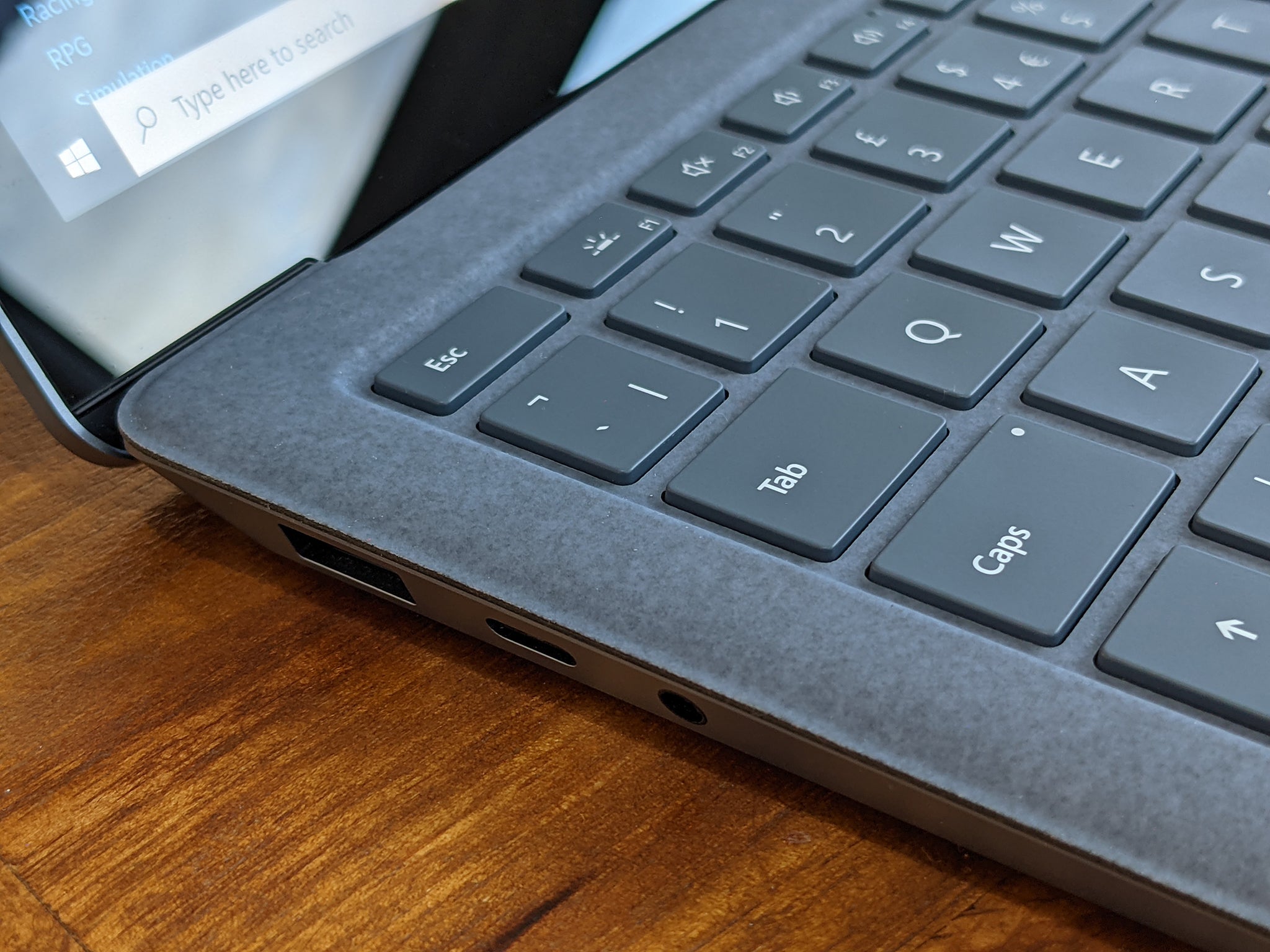 The entire speaker is situated beneath the keyboard to avoid any visible grilles