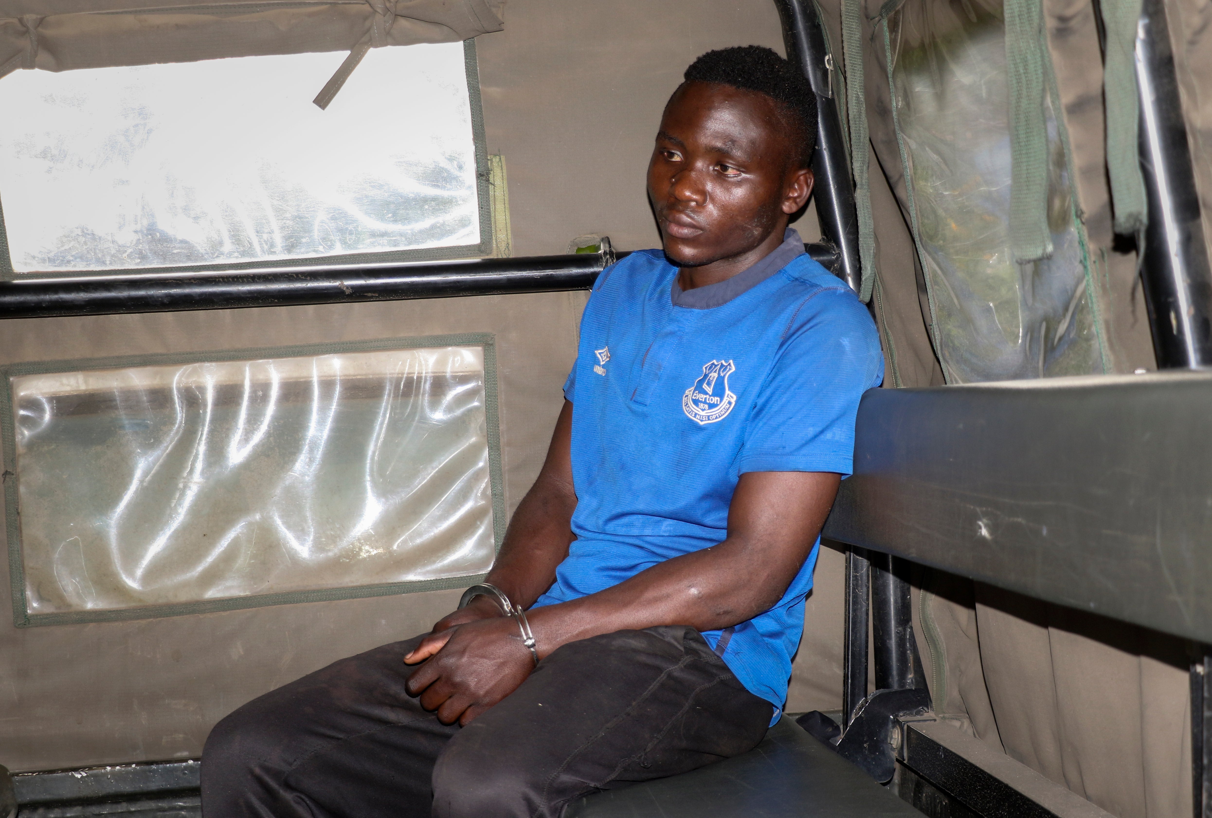 Masten Wanjala sat in the back of a police truck being taken by police to identify the location of alleged victim remains.