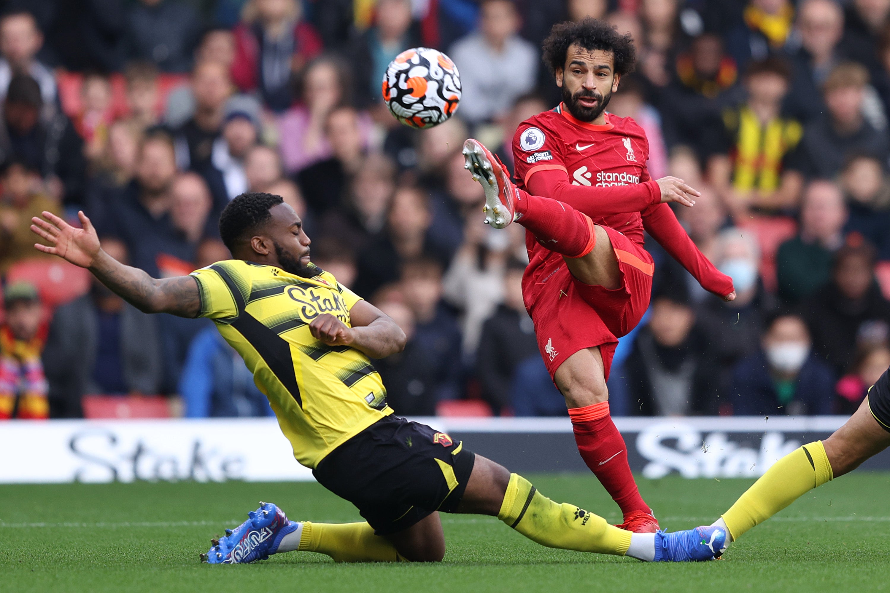 Mohamed Salah of Liverpool takes a shot as Danny Rose of Watford FC attempts to block