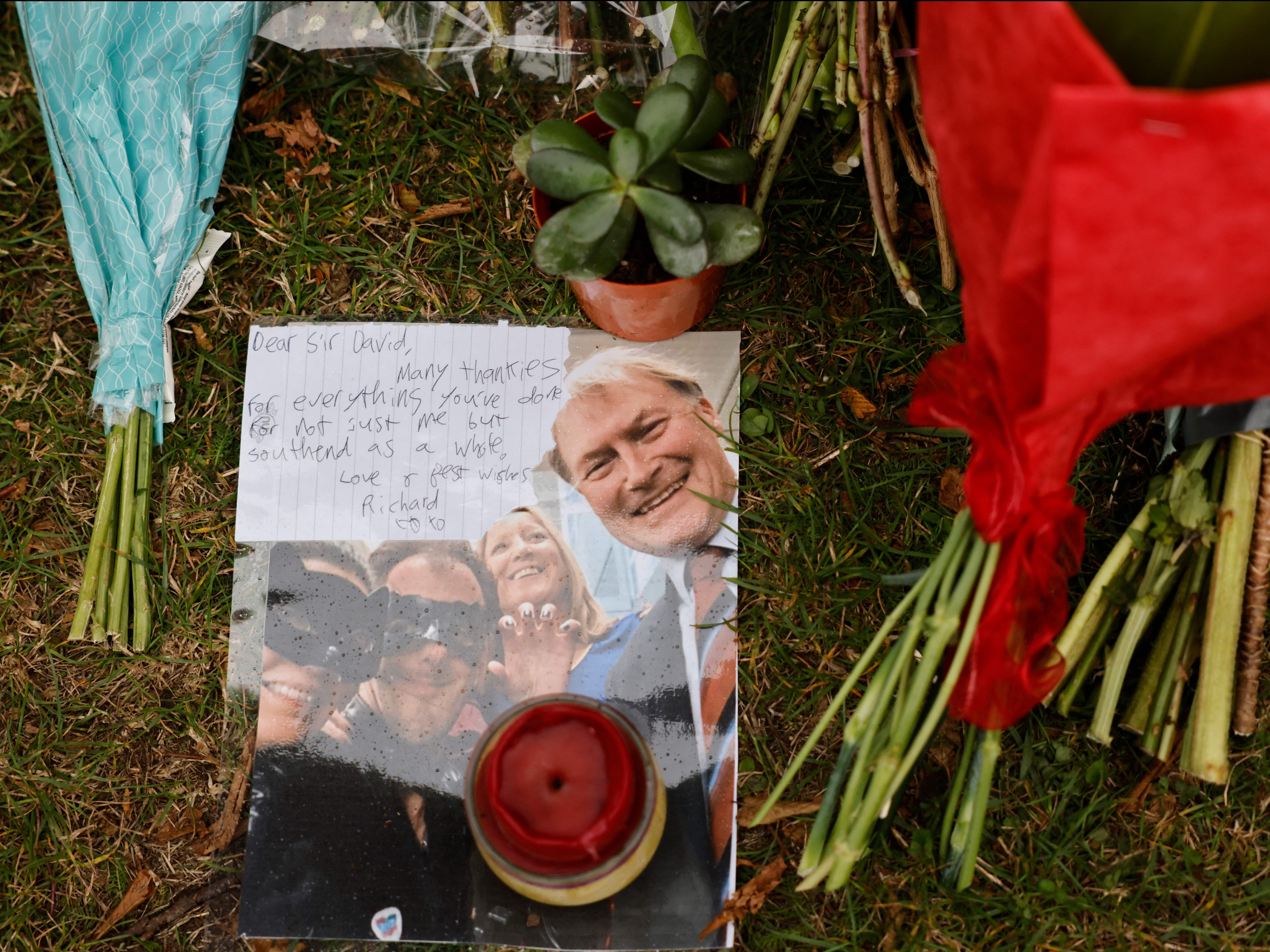 A photograph of David Amess among the floral tributes left at Belfairs Methodist Church