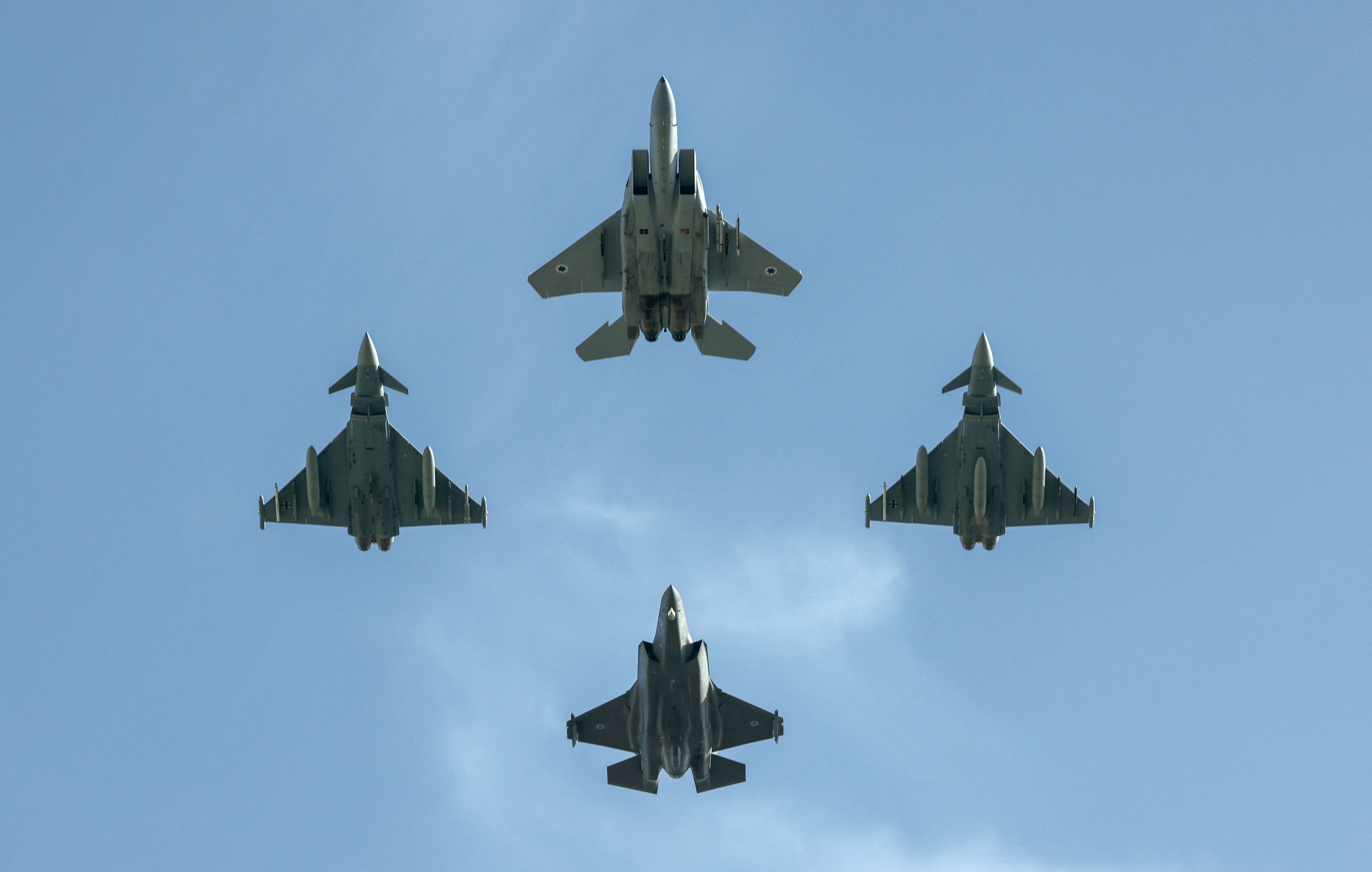 Israel and German (L and R) fighter jets fly over the Knesset, Israel’s parliament, during a flyby in a display of cooperation between the two countries and their armies, in Jerusalem