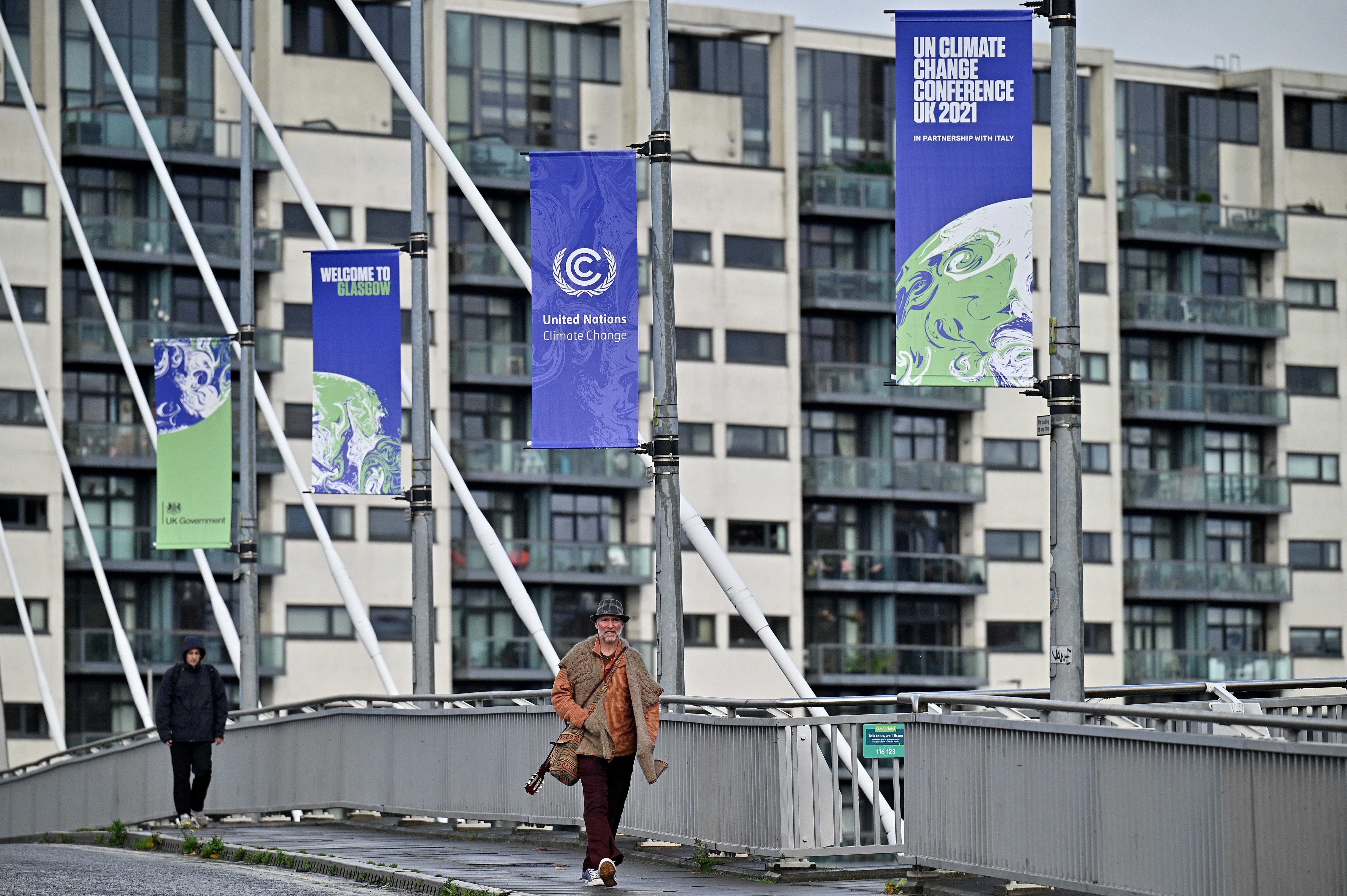 Members of the public cross the Clyde Arc road bridge by the Scottish Events Centre which will be hosting the Cop26 UN Climate Summit