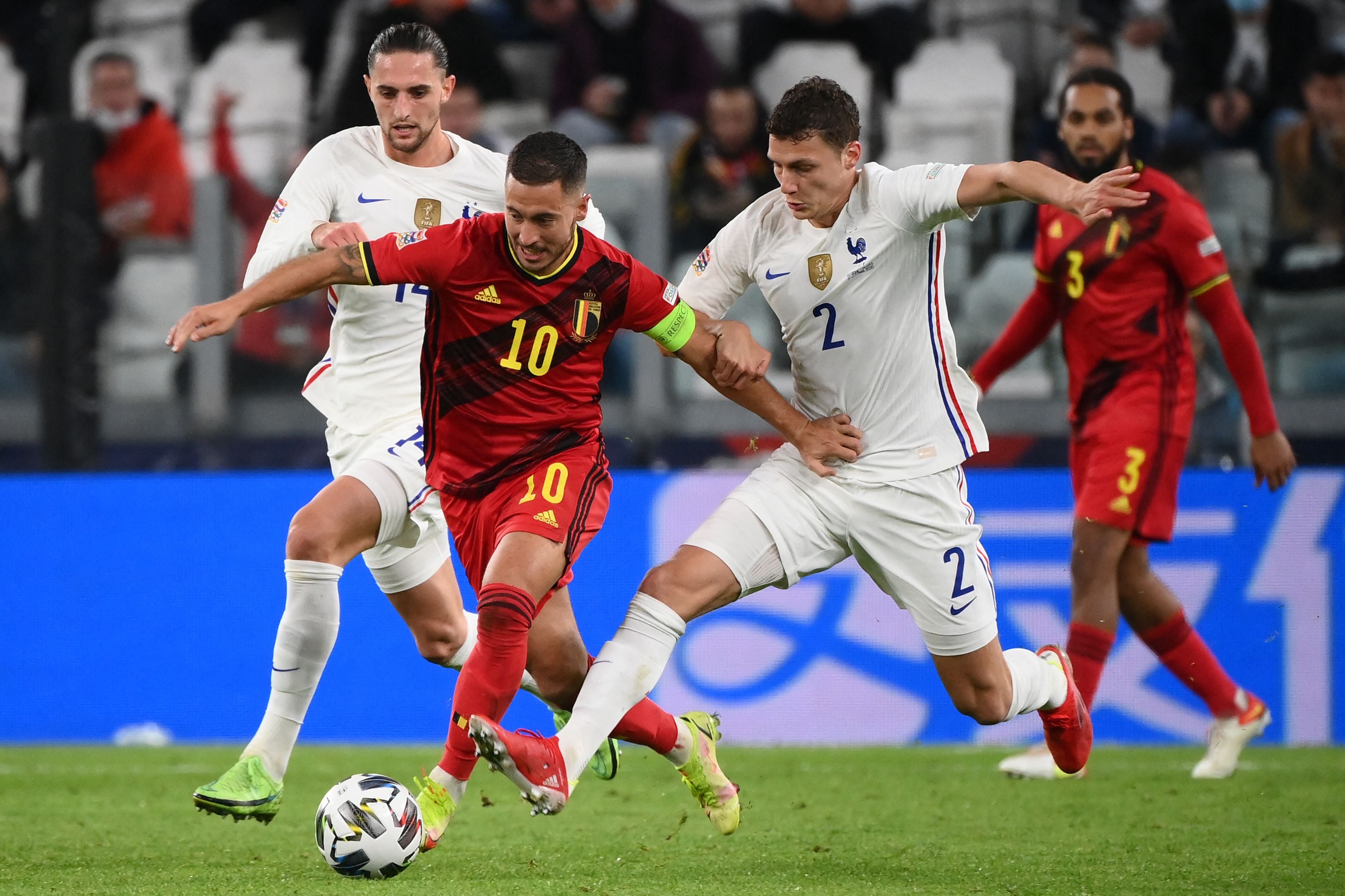 Benjamin Pavard tries to challenge Eden Hazard