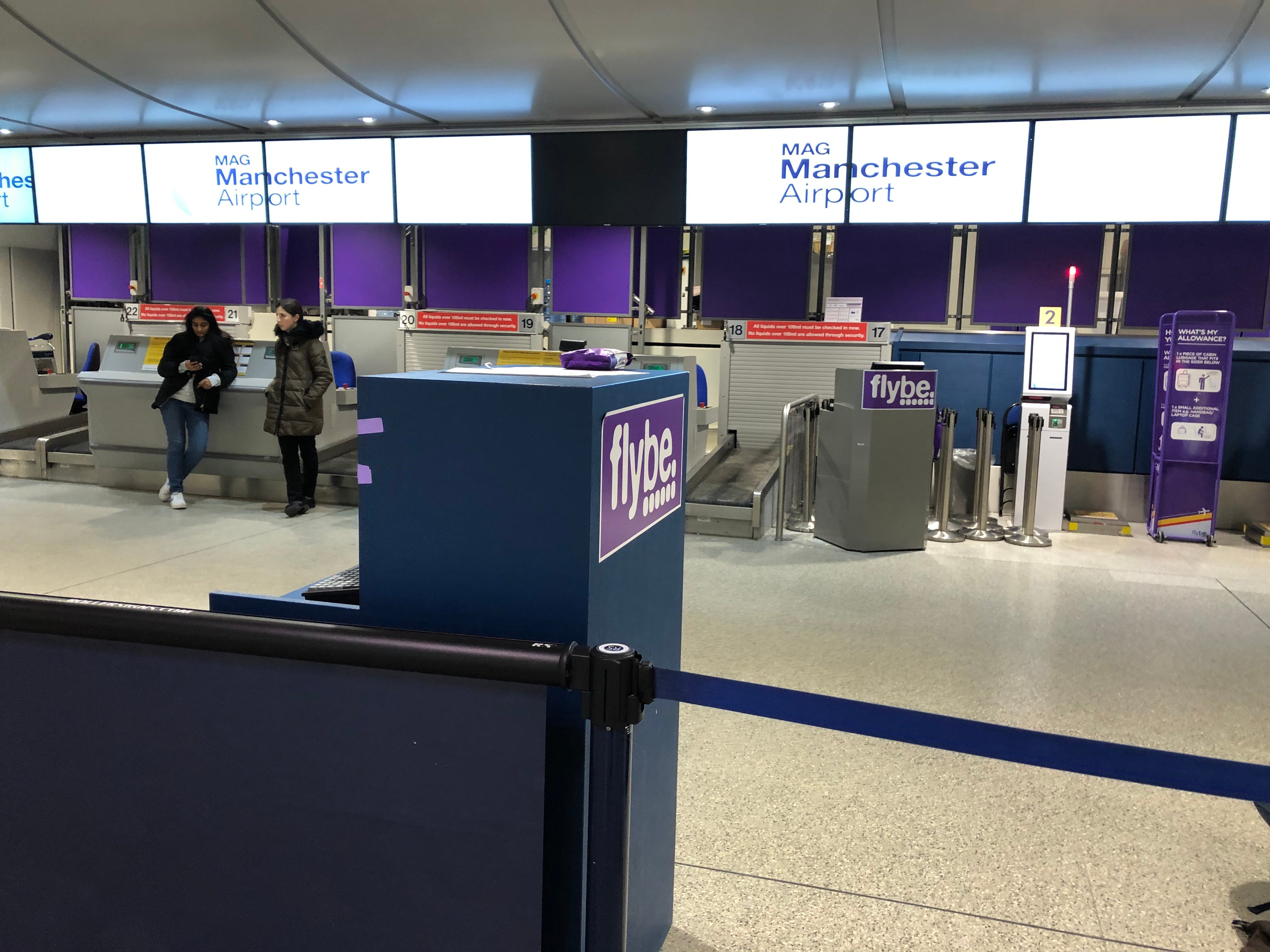 Check-in desks are shown at Manchester Airport.