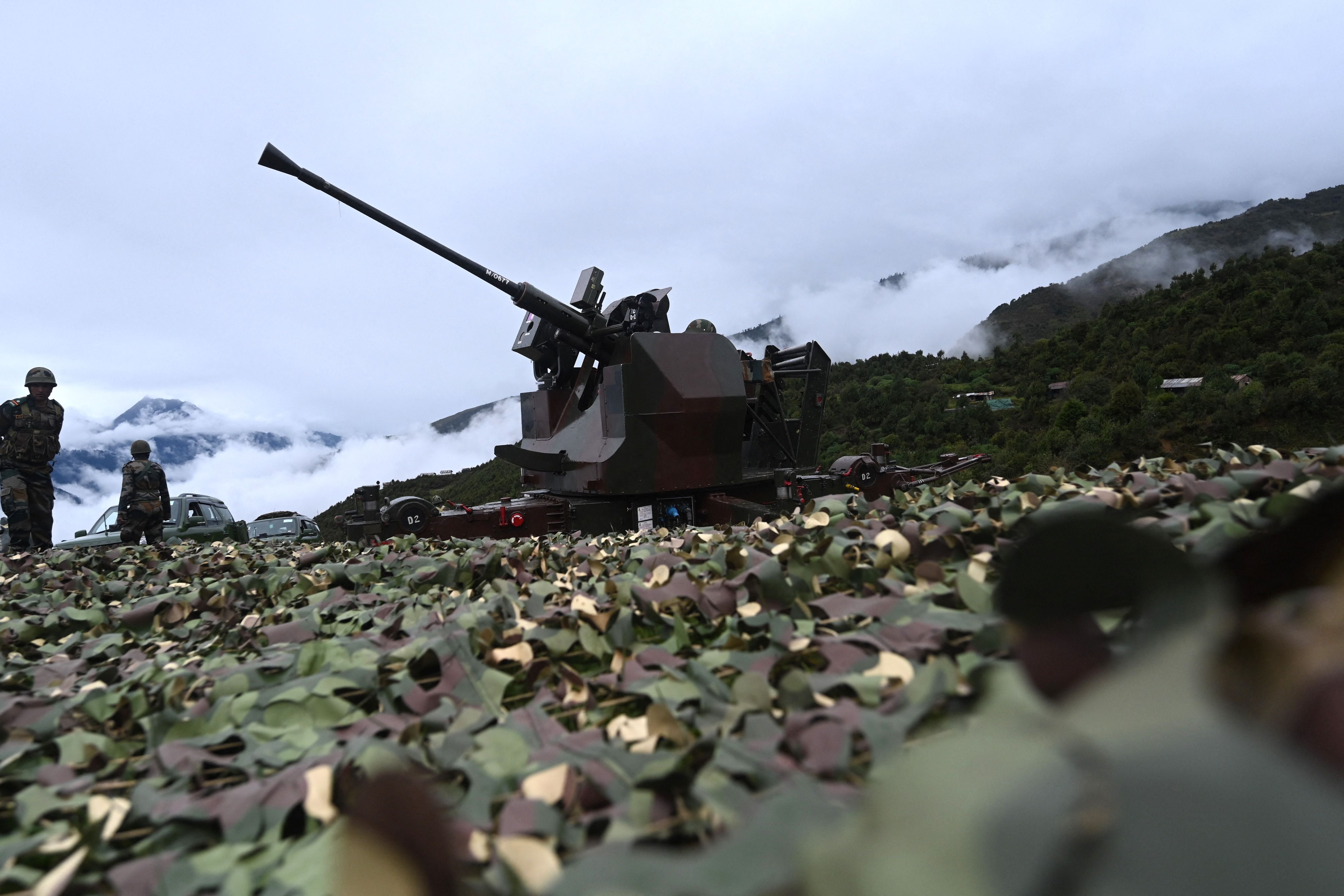 An Indian Army soldier sits inside an upgraded L70 anti aircraft gun in Tawang, near the LAC in the northeast Indian state of Arunachal Pradesh in October 2021