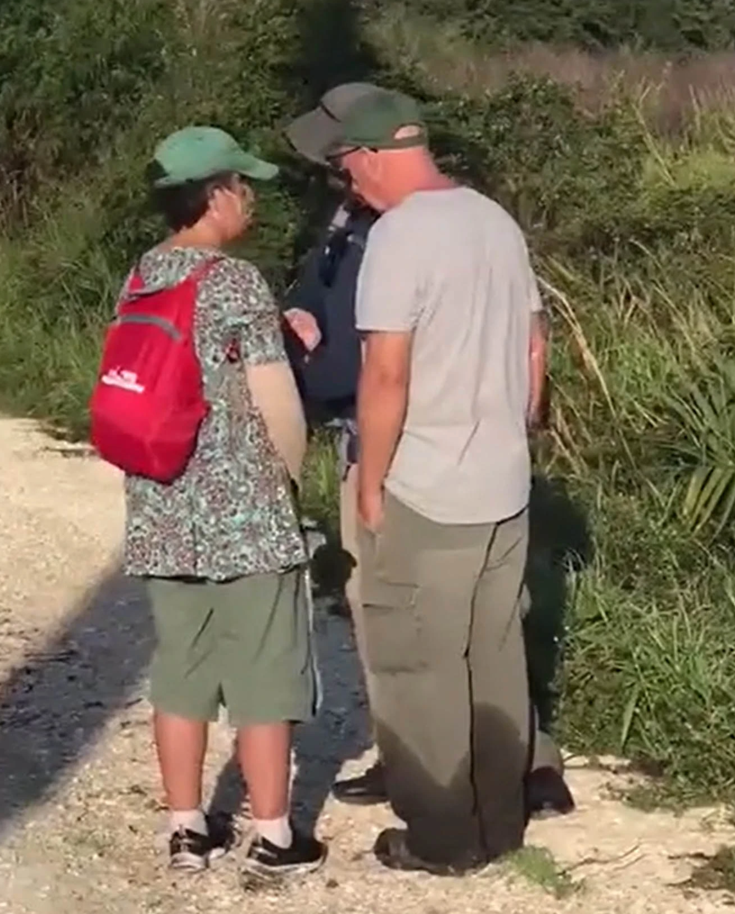 Roberta and Chris Laundrie speak to a law enforcement officer on Wednesday