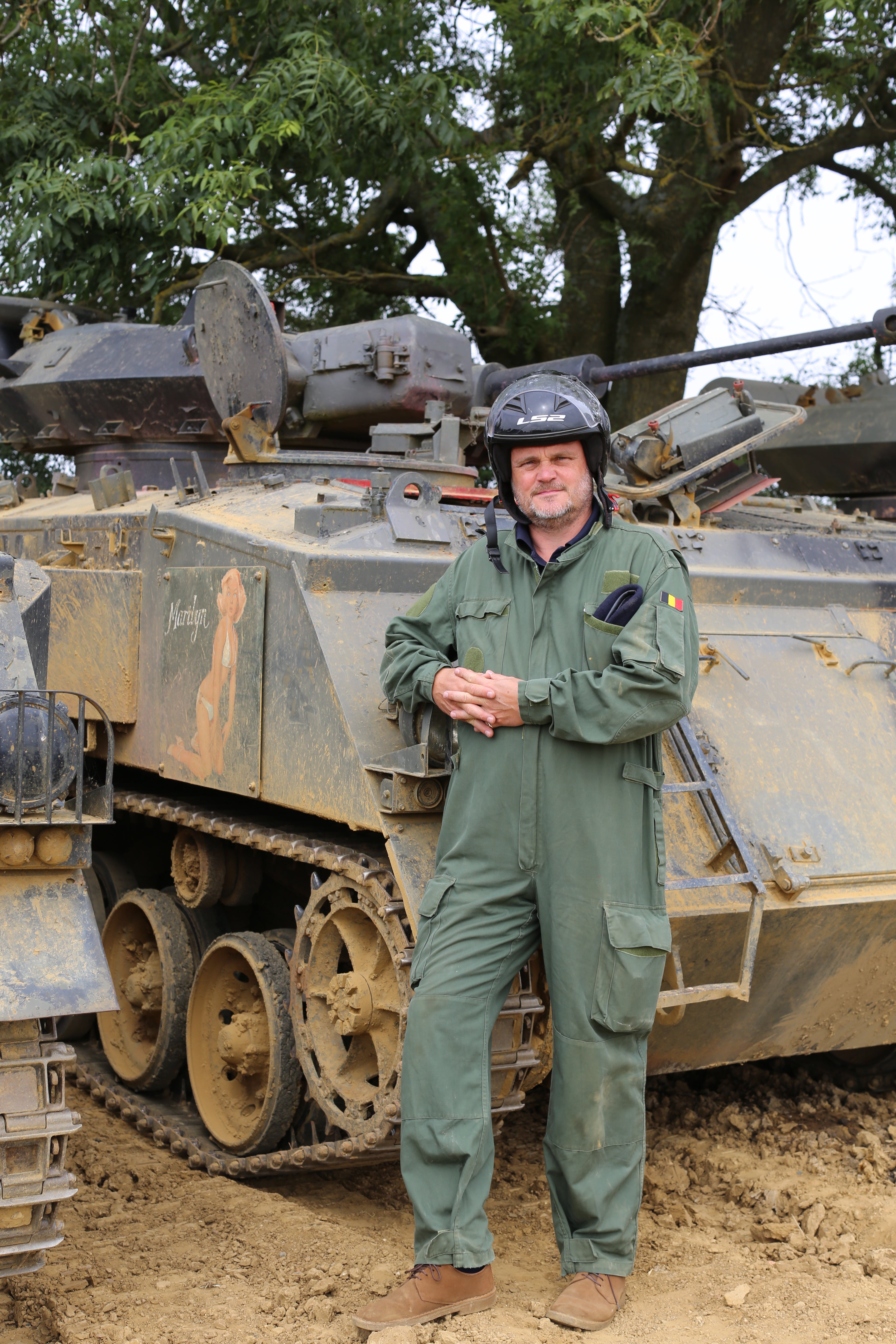 Murray, who hosts a Second World War podcast, stands in front of a tank