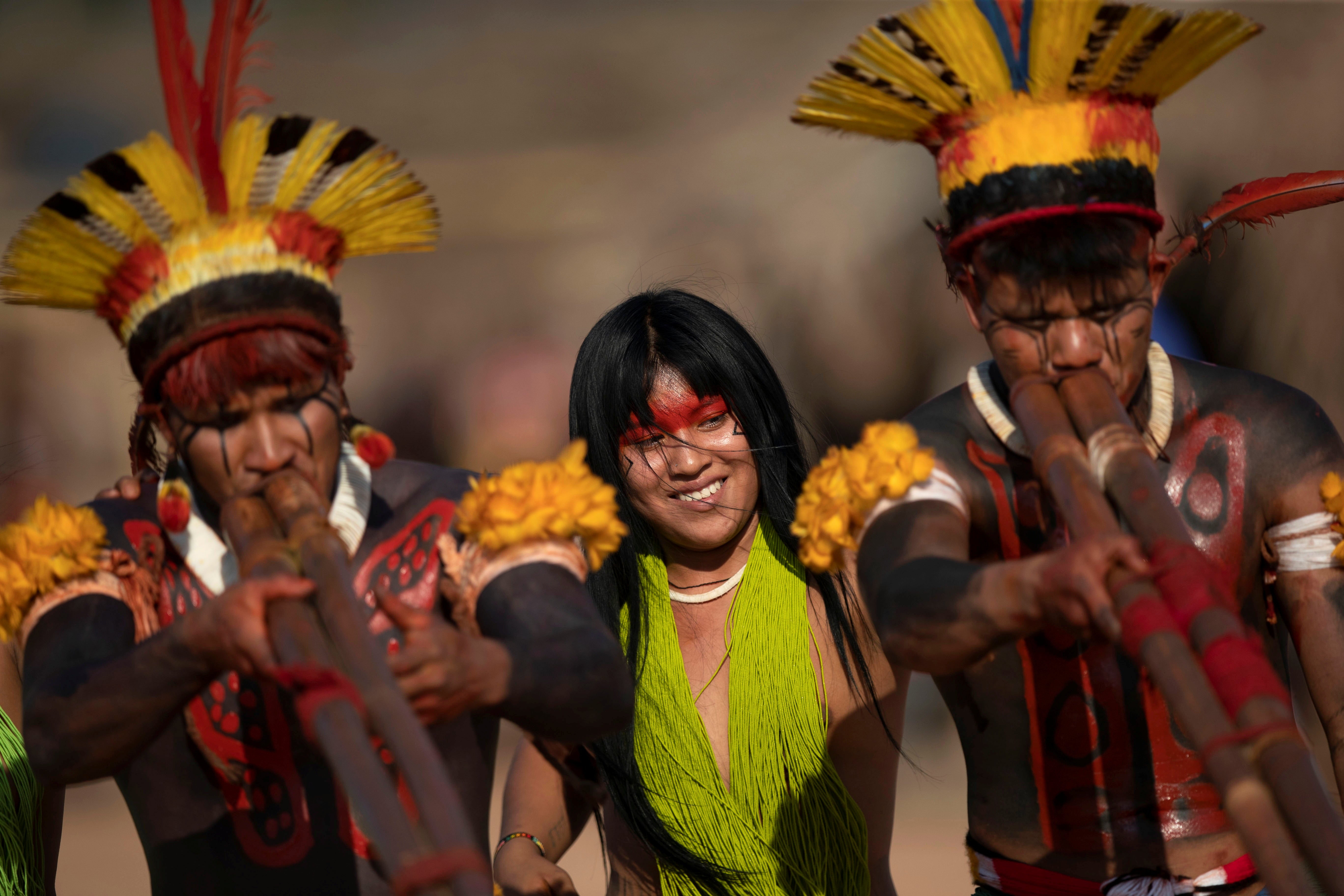 Yawalapiti, Kalapalo and Mehinako people play the urua bamboo flutes as they dance