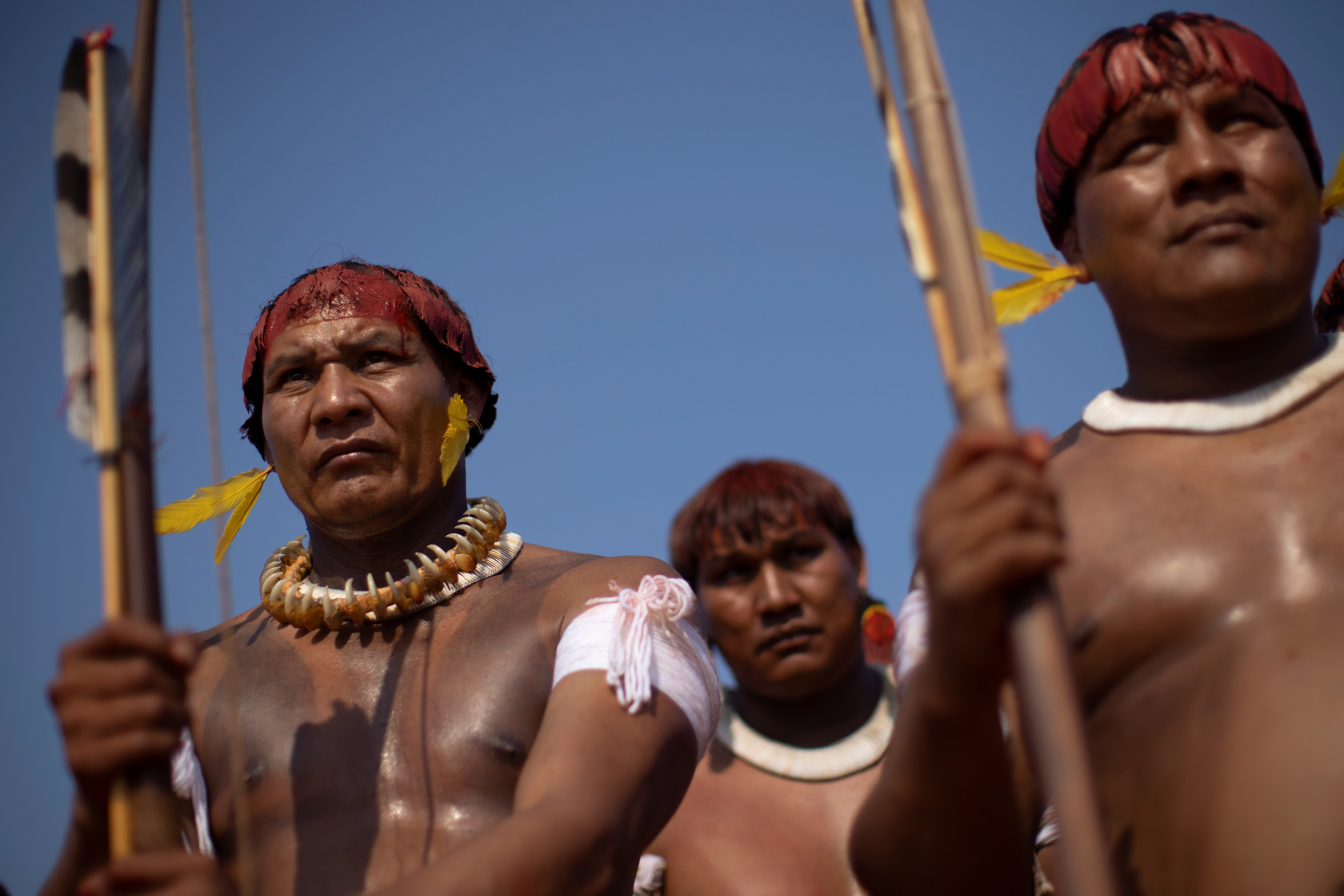 Tapi Yawalapiti and his brother Walako observe the struggles between indigenous men during the Kuarup funeral ritual