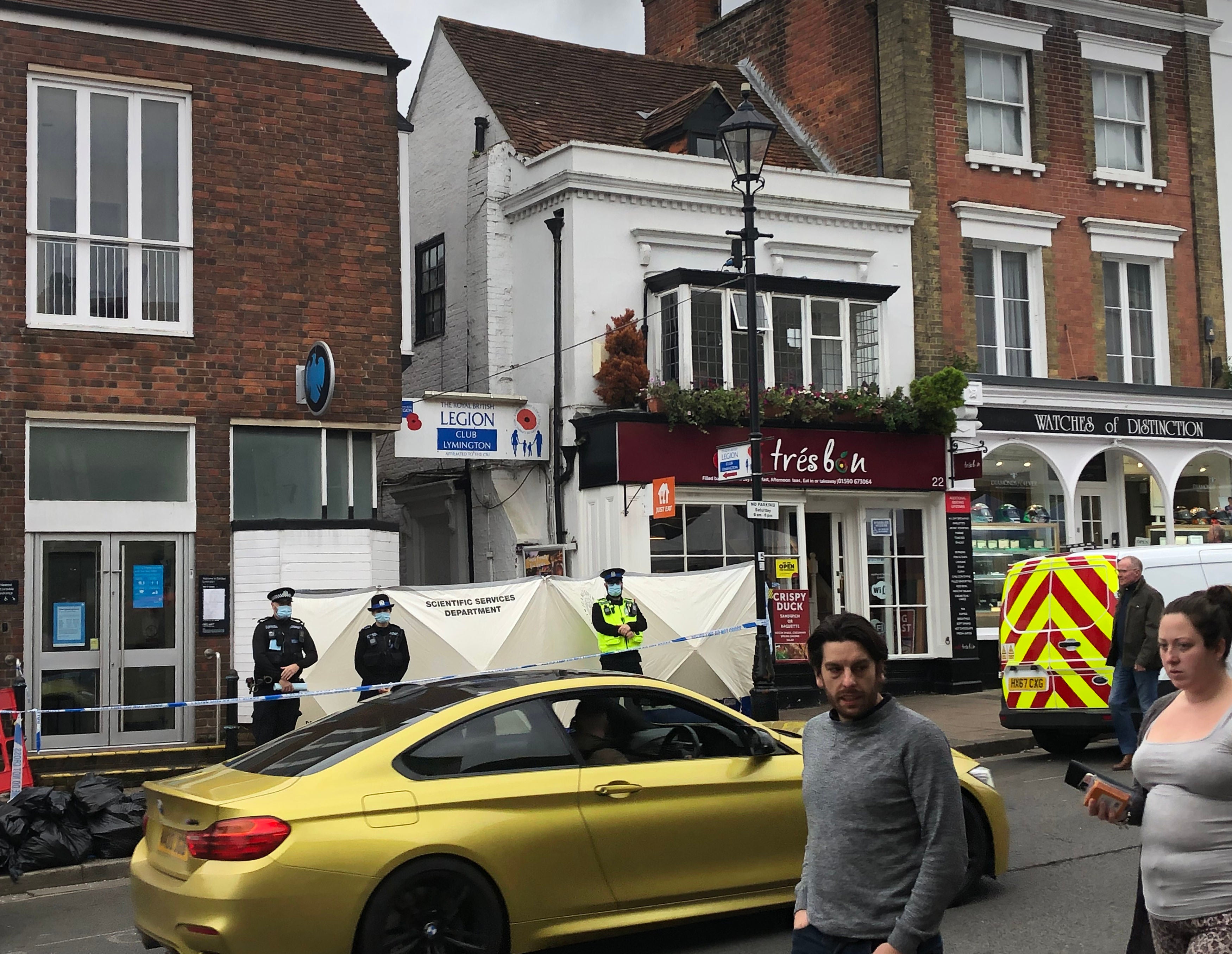 Police at the scene outside the Royal British Legion on High Street in Lymington, Hampshire, where two men and a woman were found with stab wounds on Friday