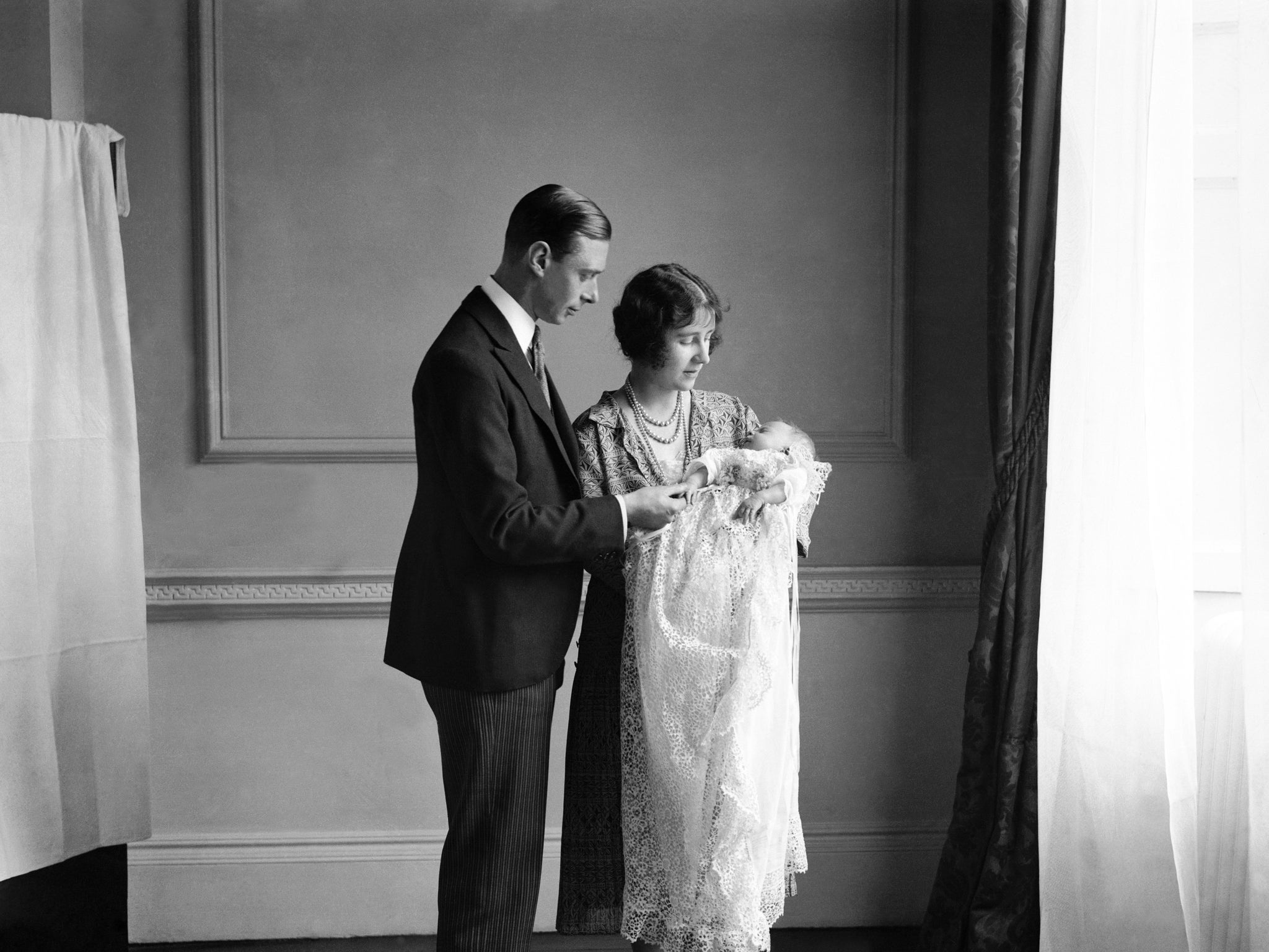 The Queen Mother (then the Duchess of York) with her husband, King George VI (then the Duke of York), and their daughter Queen Elizabeth II (then Princess) at her christening in May 1926