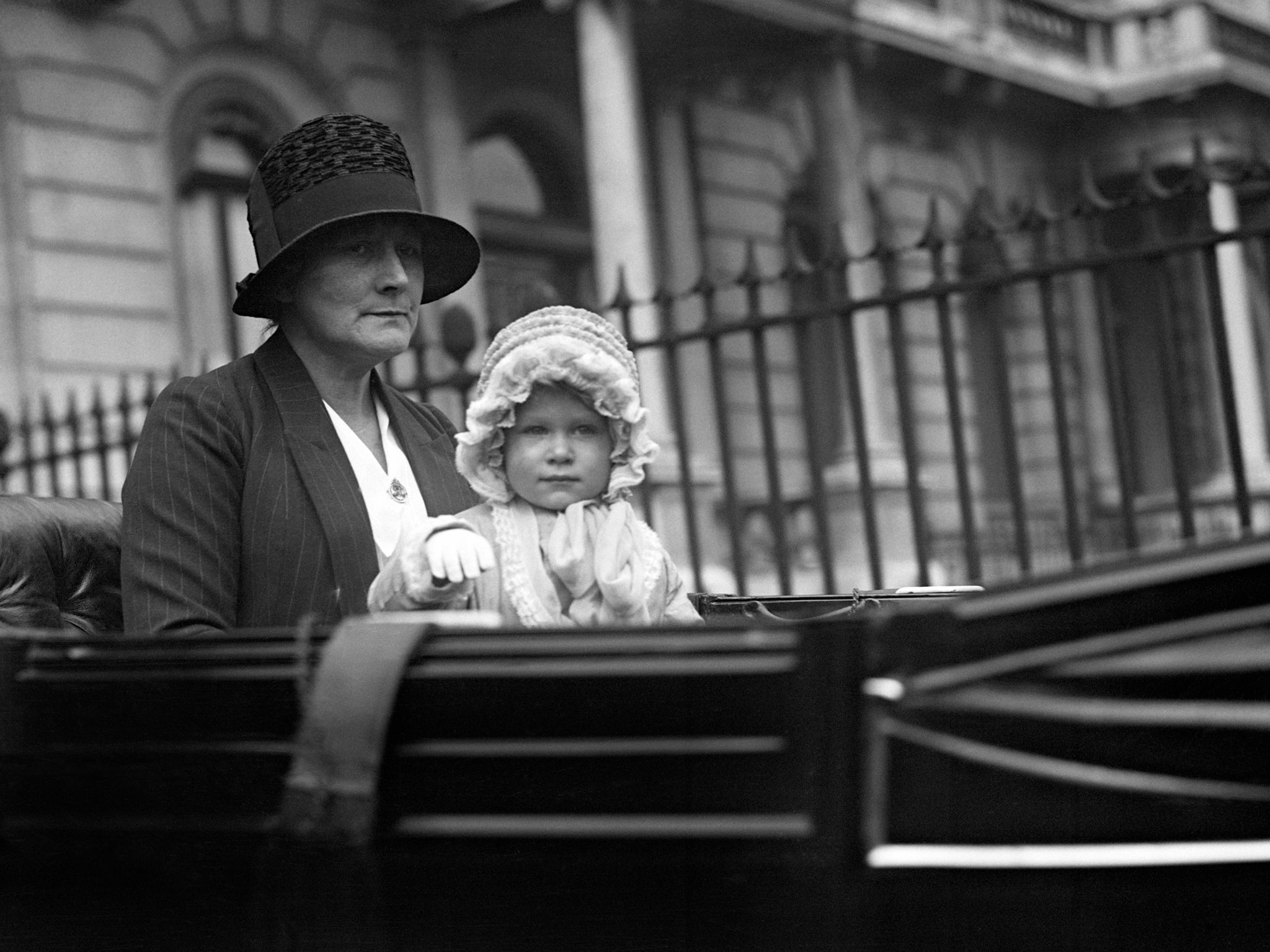 Aged two, Princess Elizabeth waves to crowds as she arrives back in Piccadilly in 1928