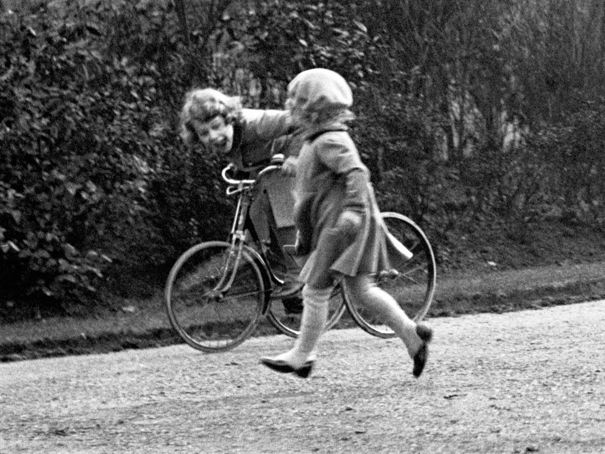 Aged six, Princess Elizabeth rides a tricycle in the park