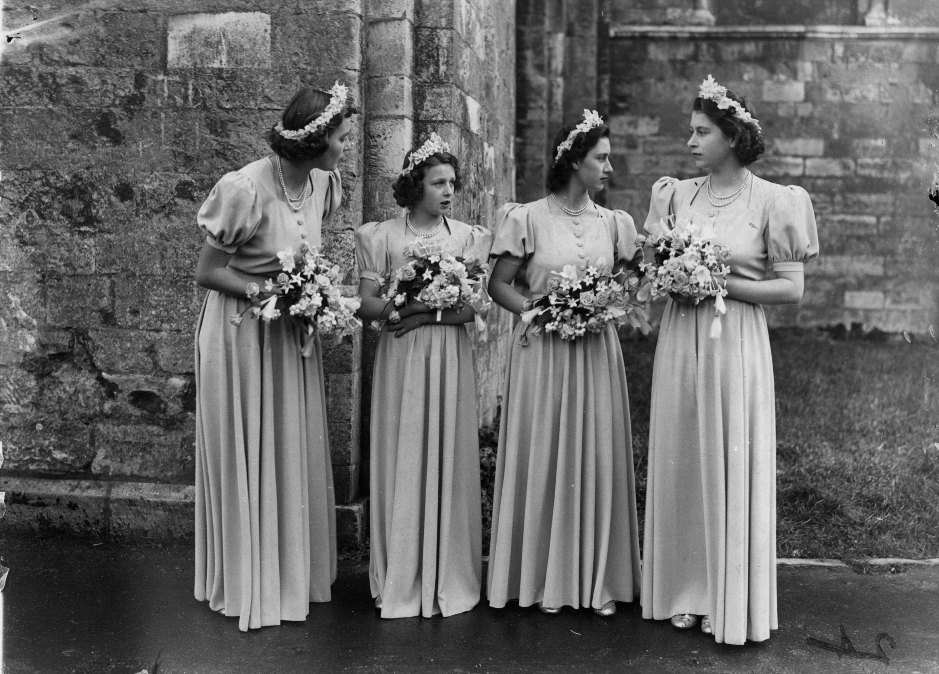 The bridesmaids at the wedding of Honourable Patricia Mountbatten and Lord Brabourne. From left: Honourable Patricia Mountbatten, sister of the bride, Princess Alexandra of Kent, Princess Elizabeth and Princess Margaret at Romsey Abbey