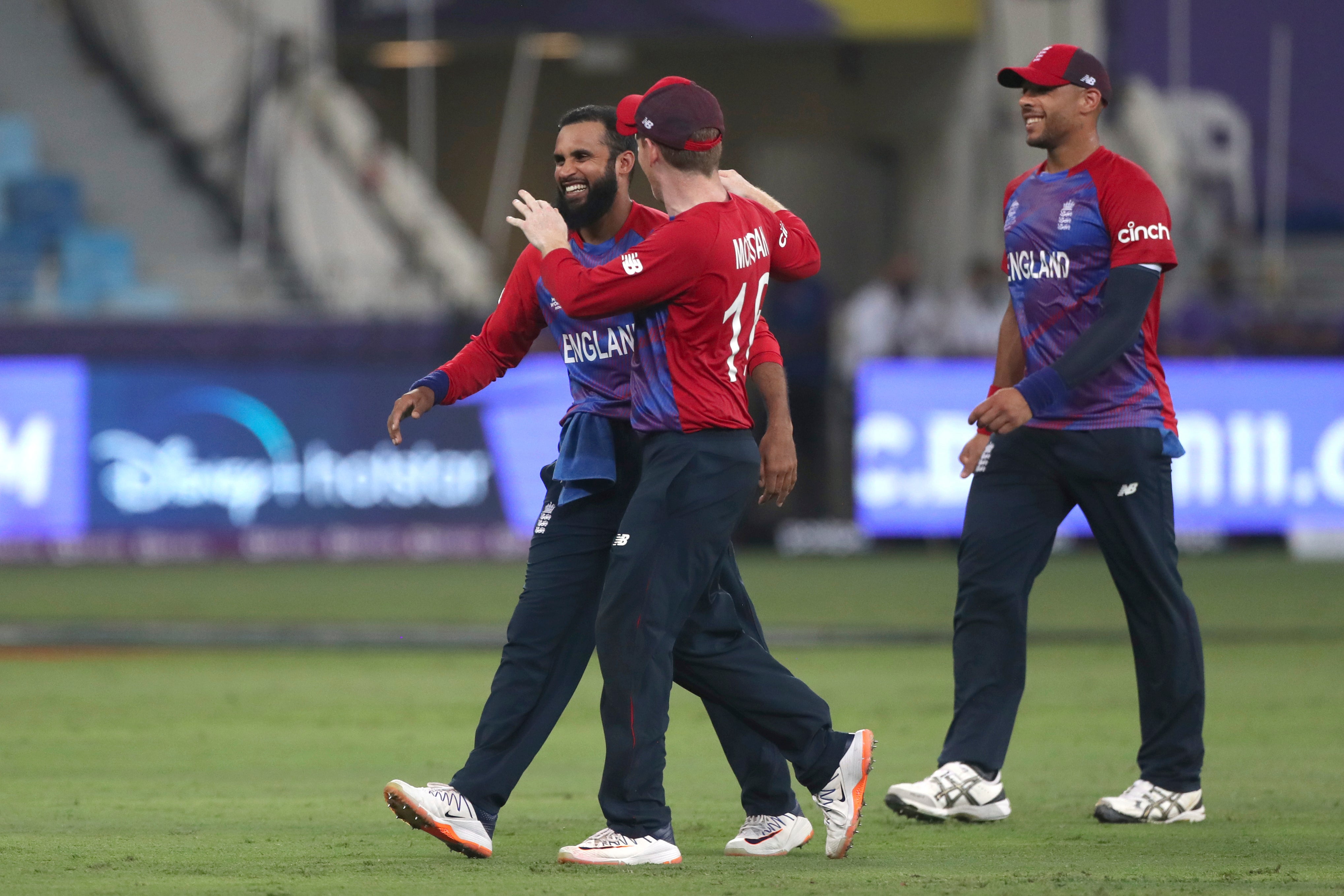 England’s Adil Rashid, left is congratulated by captain Eoin Morgan (Aijaz Rahi/AP).