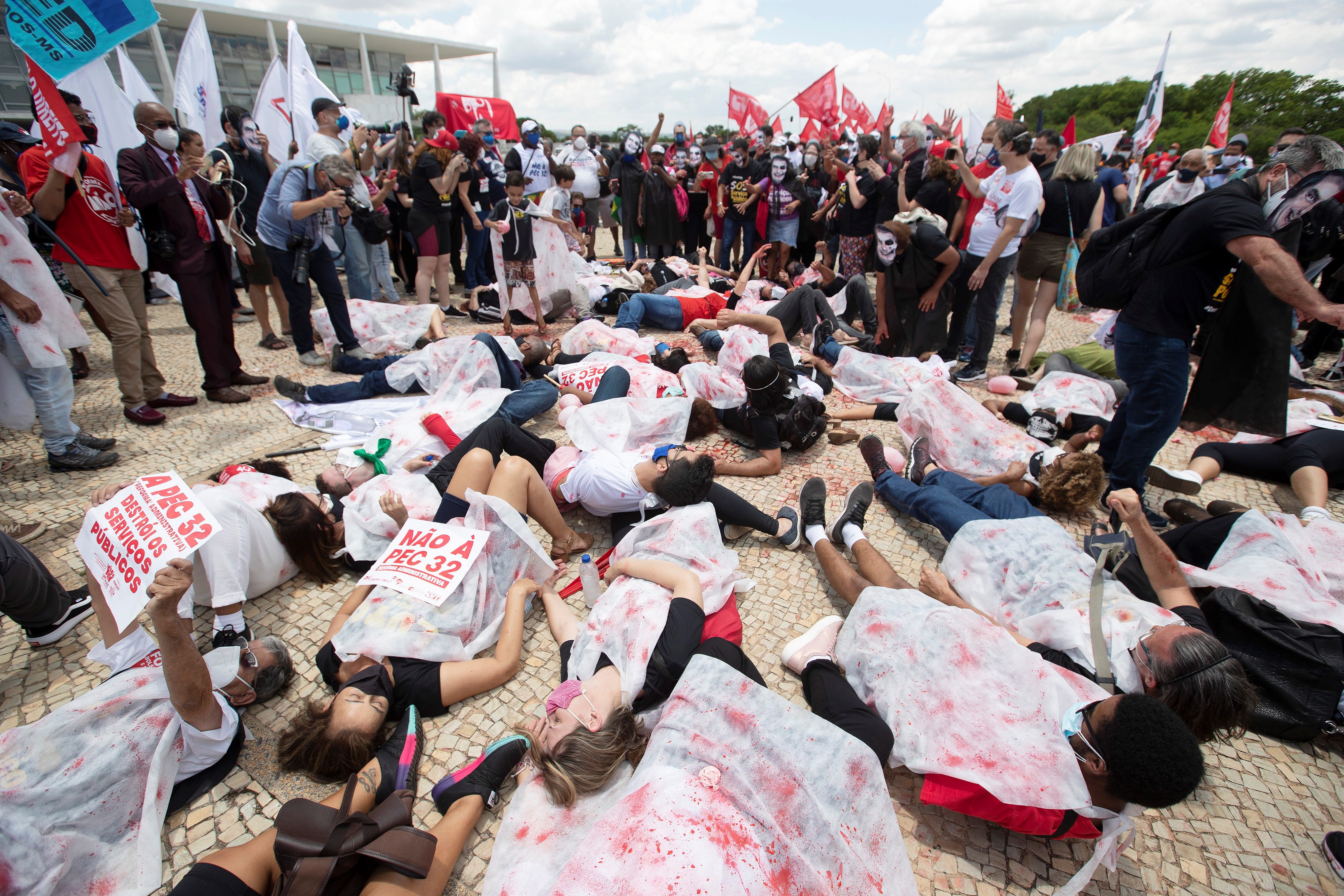 Protesters lie on the ground to represent coronavirus fatalities during a demonstration against the president of Brazil, Jair Bolsonaro