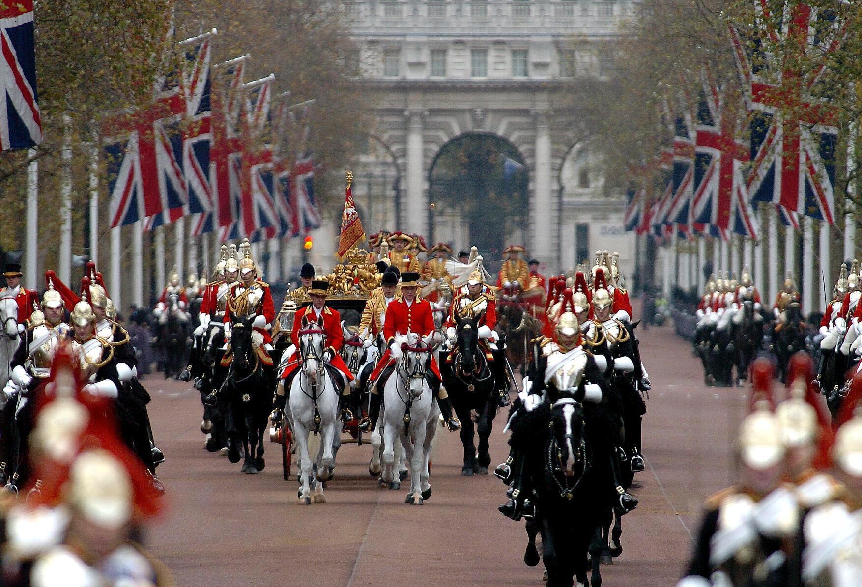 Queen Elizabeth II, accompanied by the Duke of Edinburgh return from the House of Lords in a horse-drawn carriage to Buckingham Palace, London