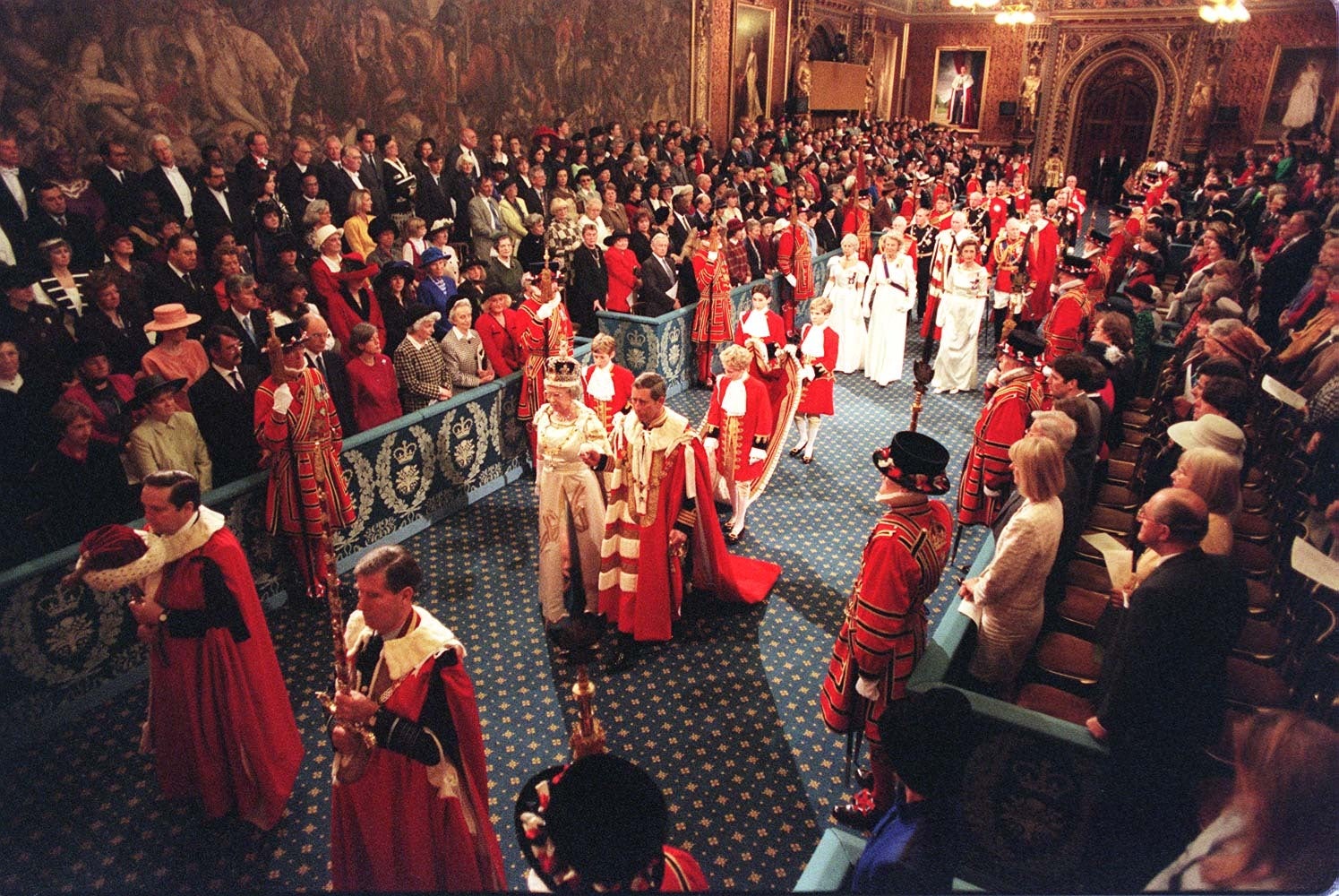 A general view of the Queen and the Prince of Wales walking through the Royal Gallery on their way to the House of Lords