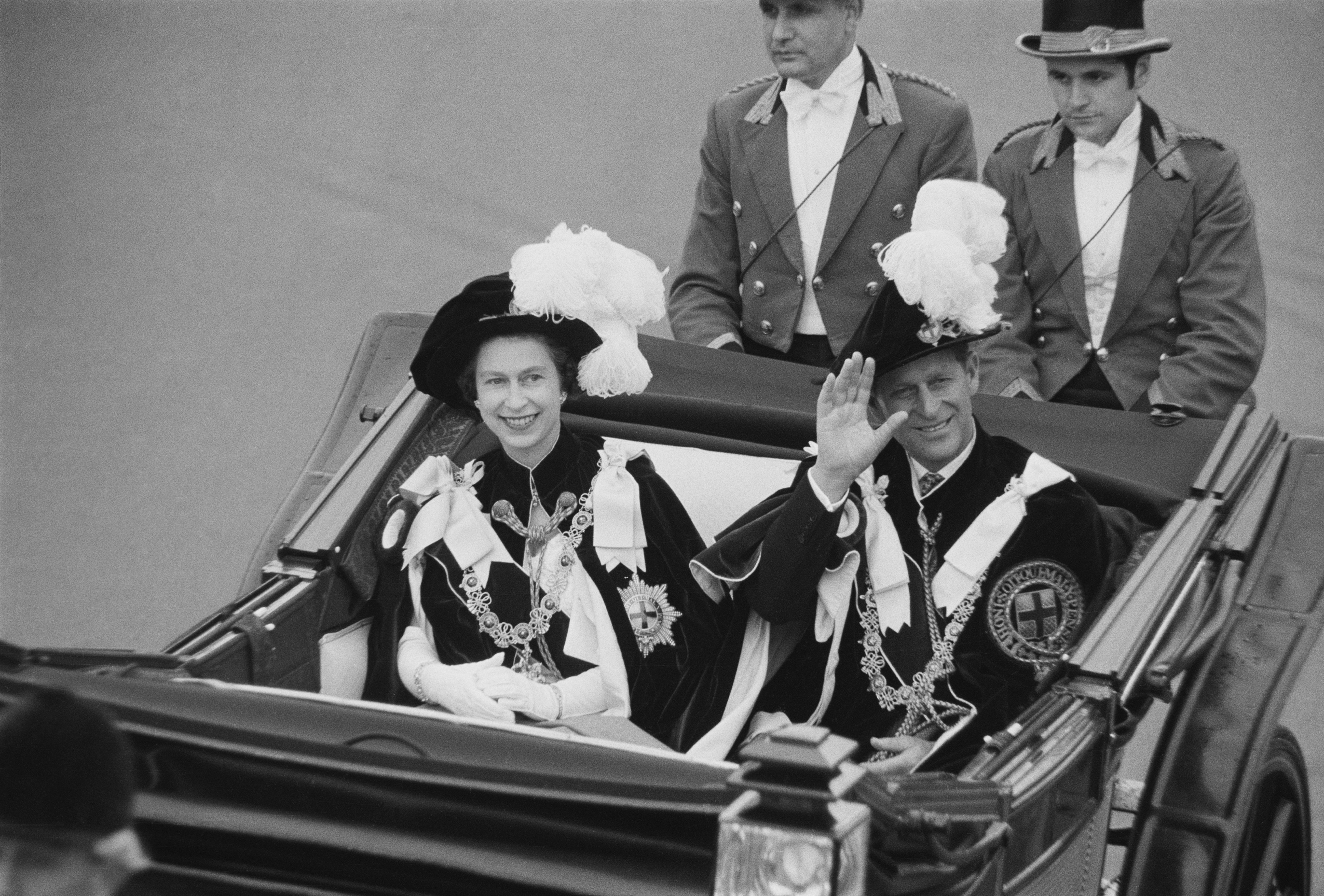 Prince Philip, Duke of Edinburgh and Queen Elizabeth II wave to crowds during the Garter Procession at Windsor Castle, 1969