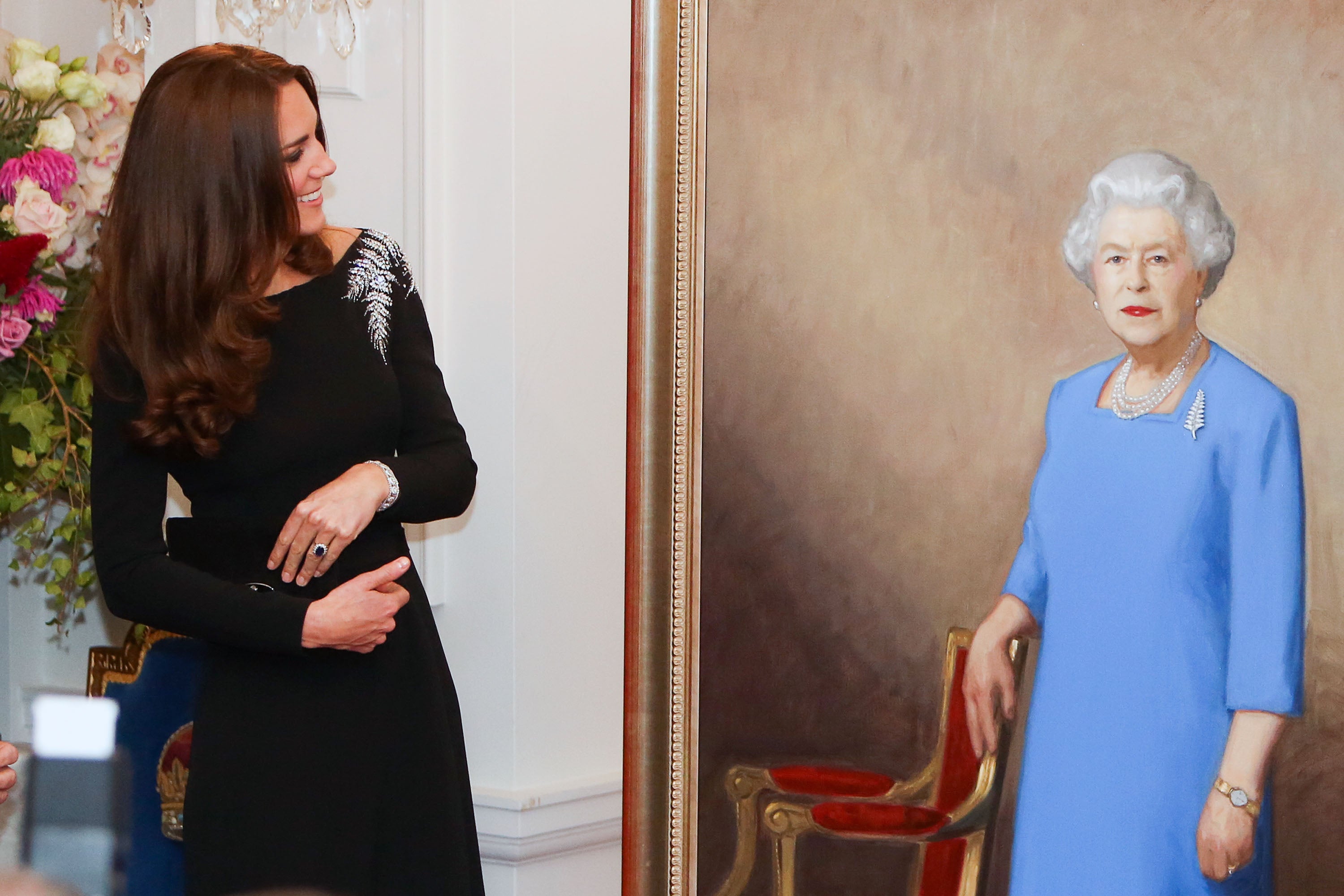 Catherine, Duchess of Cambridge inspects a portrait of Queen Elizabeth II, painted by New Zealand artist Nick Cuthell and unveiled during a state reception at Government House on April 10, 2014 in Wellington, New Zealand