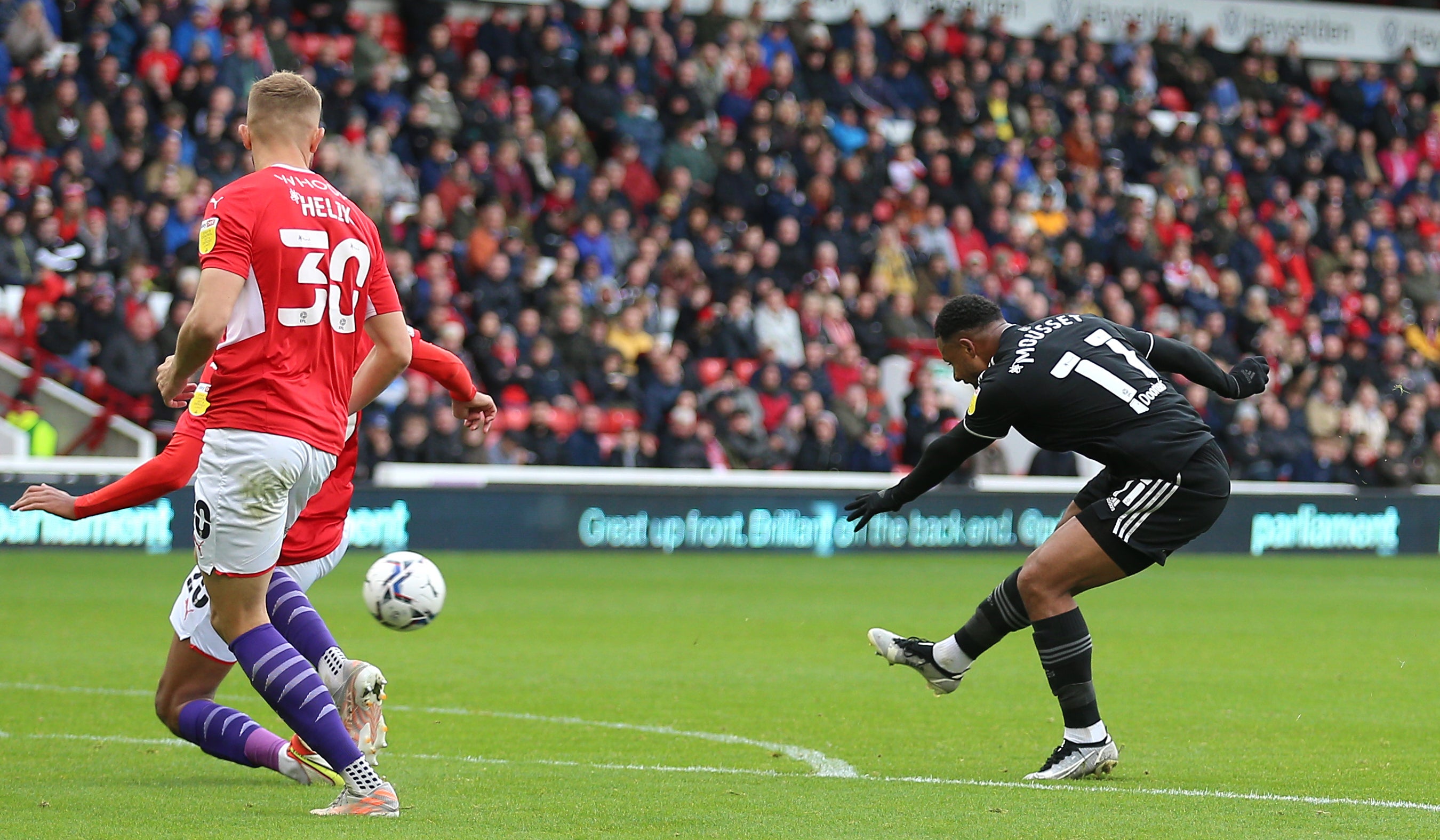 Sheffield United’s Lys Mousset (right) scores the first of his two goals in a 3-2 win at Barnsley (Nigel French/PA Images).