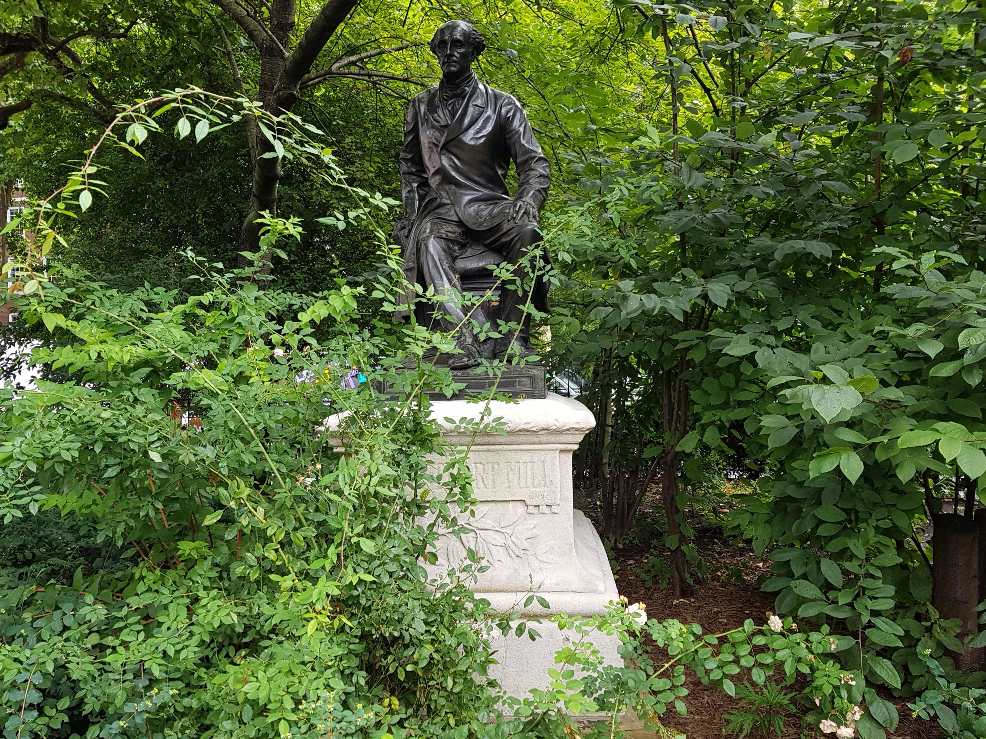 A statue of John Stuart Mill at Victoria Embankment Gardens, London