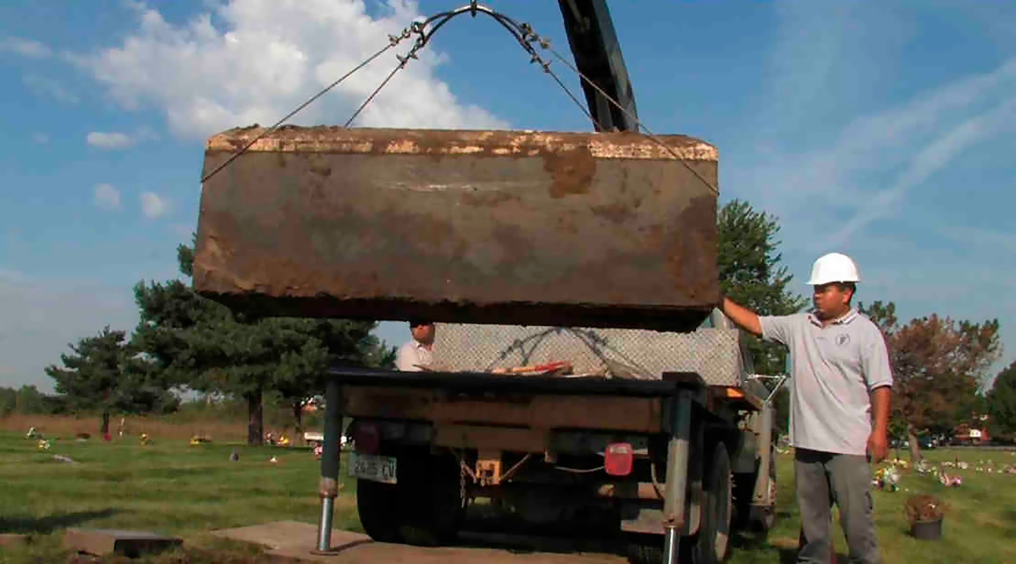 In this undated file photo provided by the Cook County Sheriff's Office, authorities exhume a box with the remains of unidentified victims of serial killer John Wayne Gacy