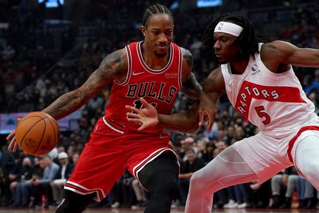 Chicago Bulls forward DeMar DeRozan drives to the net as Toronto Raptors forward Precious Achiuwa defends (Nathan Denette/The Canadian Press via AP)