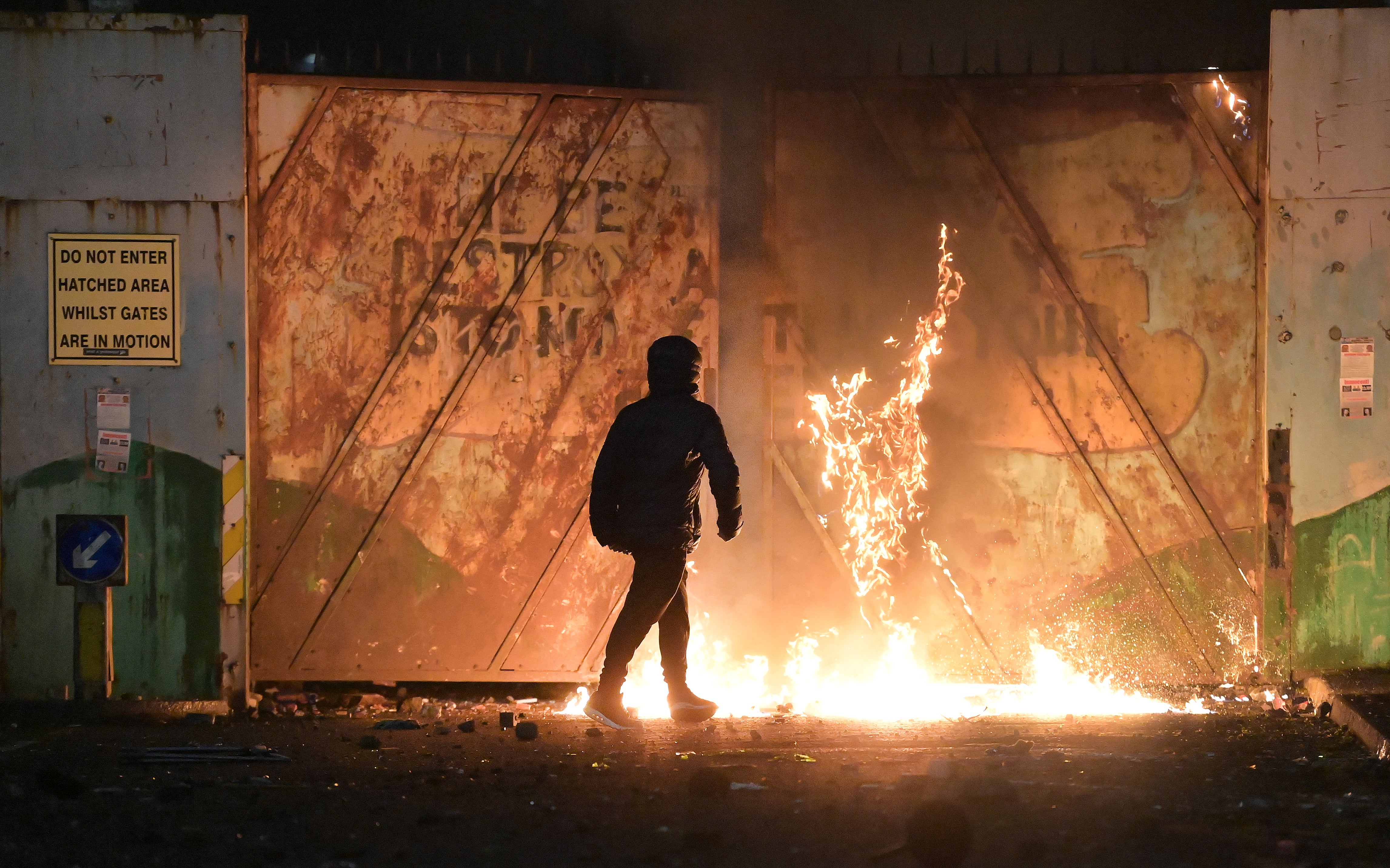 Nationalists and Loyalists rioting earlier this year at the Peace Wall gates which divide the two communities