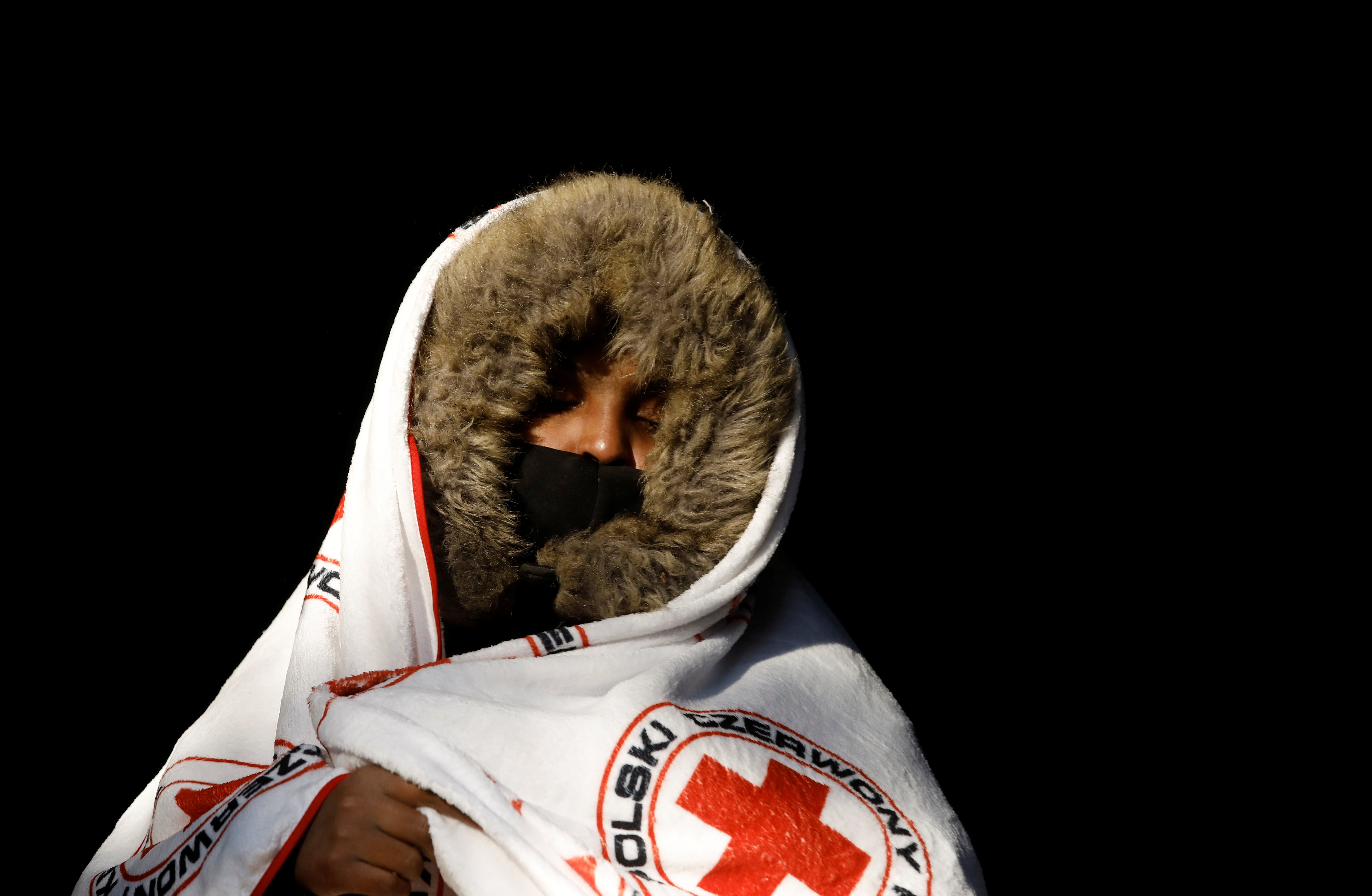 A migrant from Somalia covers herself with a blanket after crossing the Belarusian-Polish border in Siemianowka earlier this month