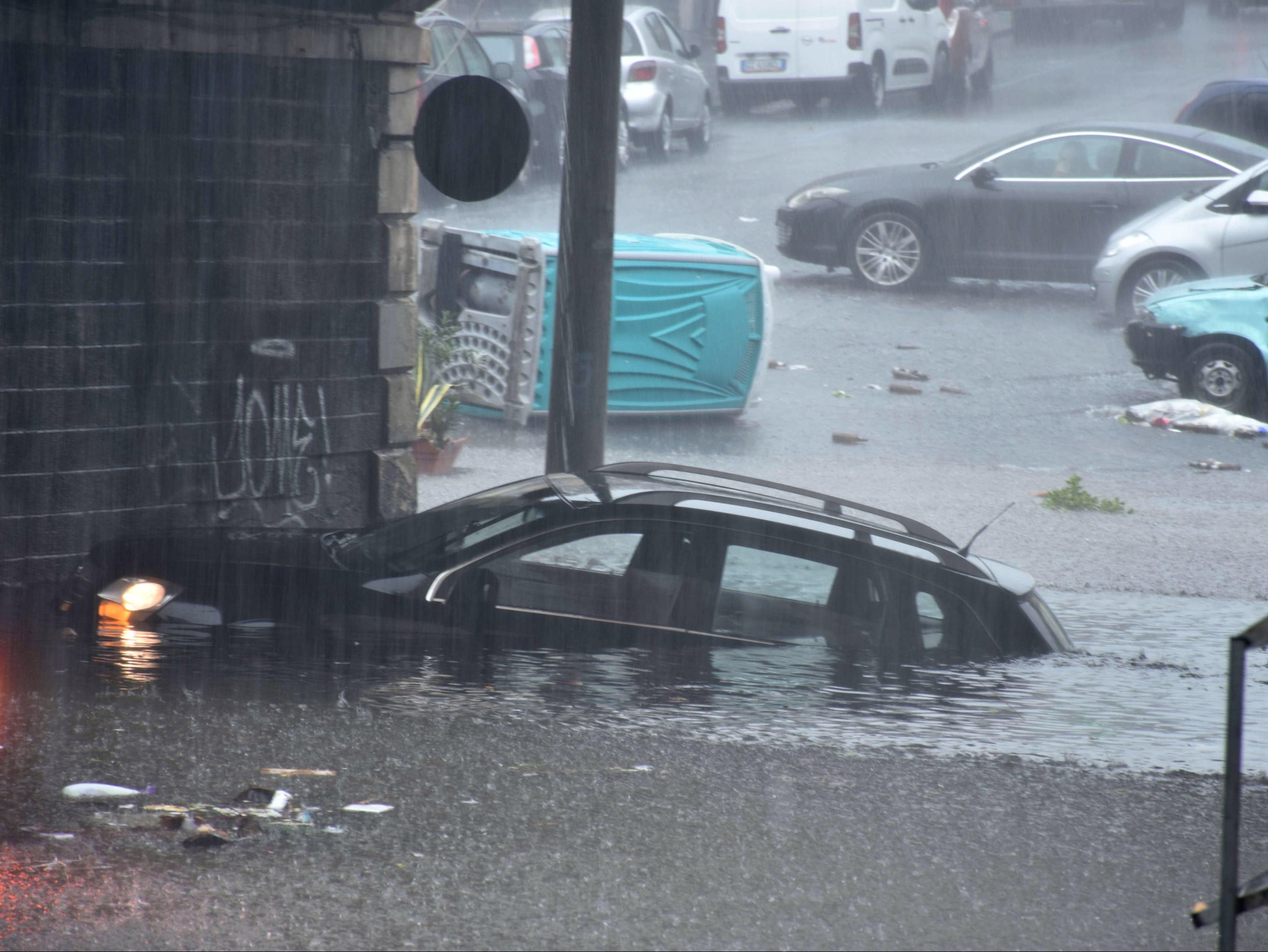 Cars were submerged in Catania as flooding hit Sicily