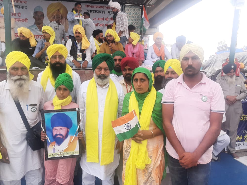 Despite her husband Dhanna Singh’s death in the protests last year, Manjeet Kaur and her children have gone to protest in Delhi several times. Kaur is pictured here with her son and her husband’s photo